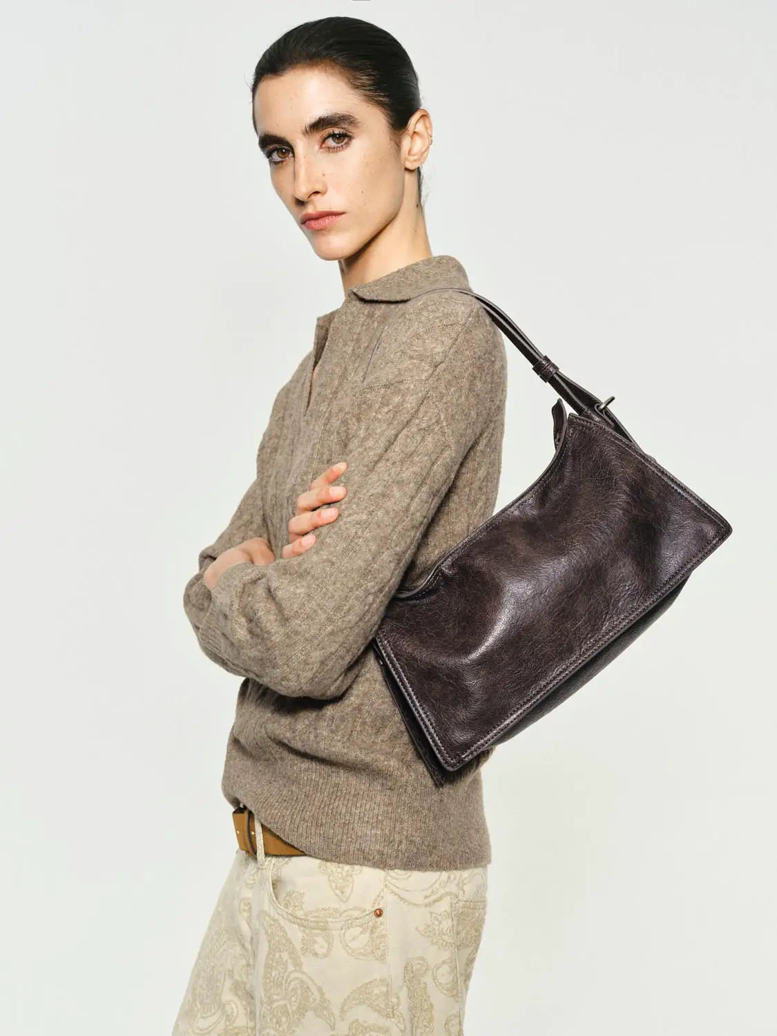 Shoulder bag by Urban Revivo Fashion in dark brown leather worn by model