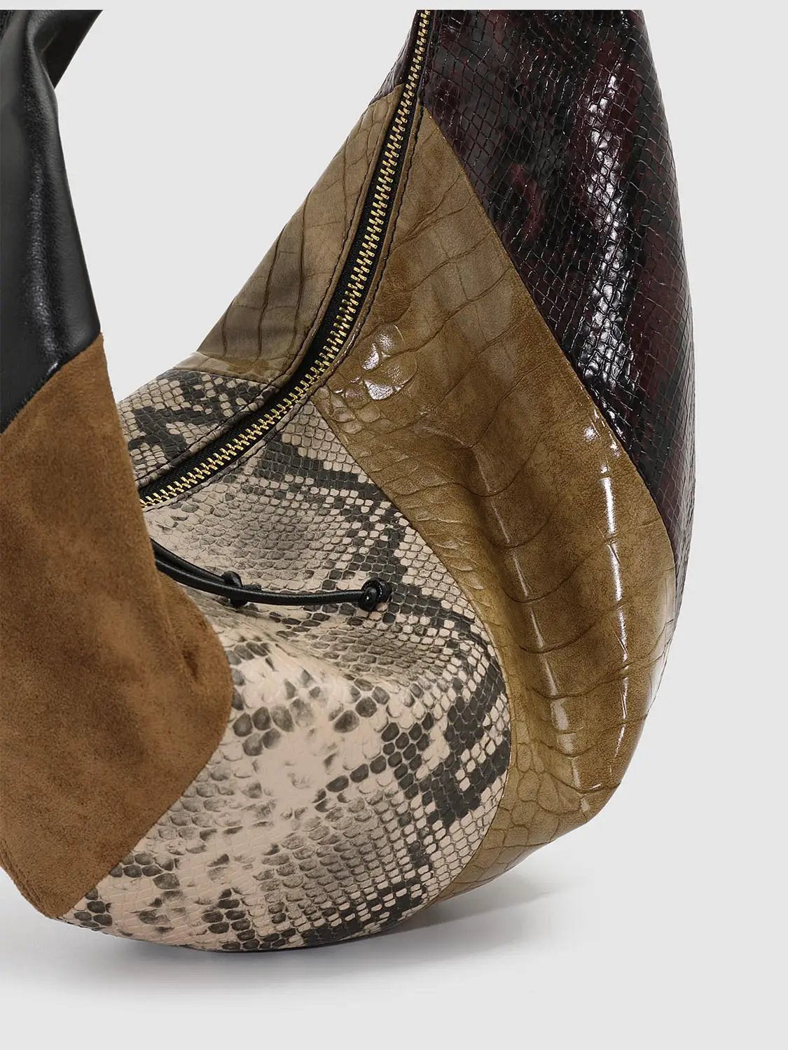 Shoulder bag with snake-print and crocodile-embossed panels, brown suede trim, and a gold zipper.