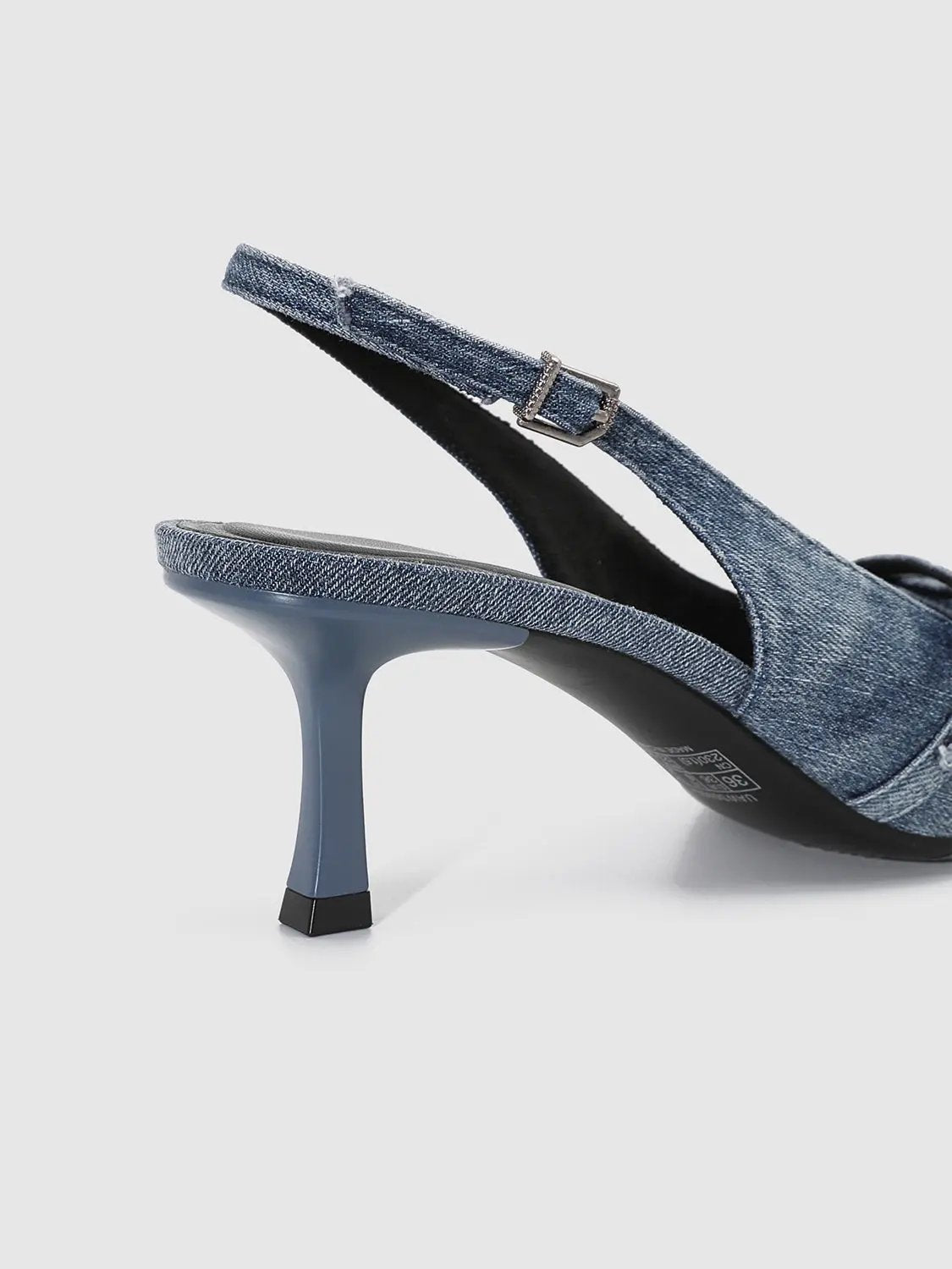 Slingback denim heel in blue with buckle strap and a slim mid-height silhouette.