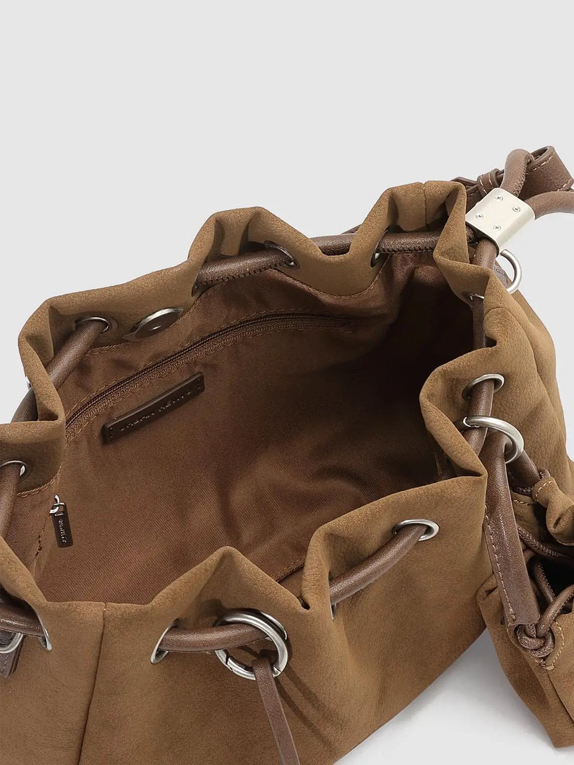 Shoulder bag by Urban Revivo Fashion in tan suede with drawstring top, metal rings, and interior zipper pocket