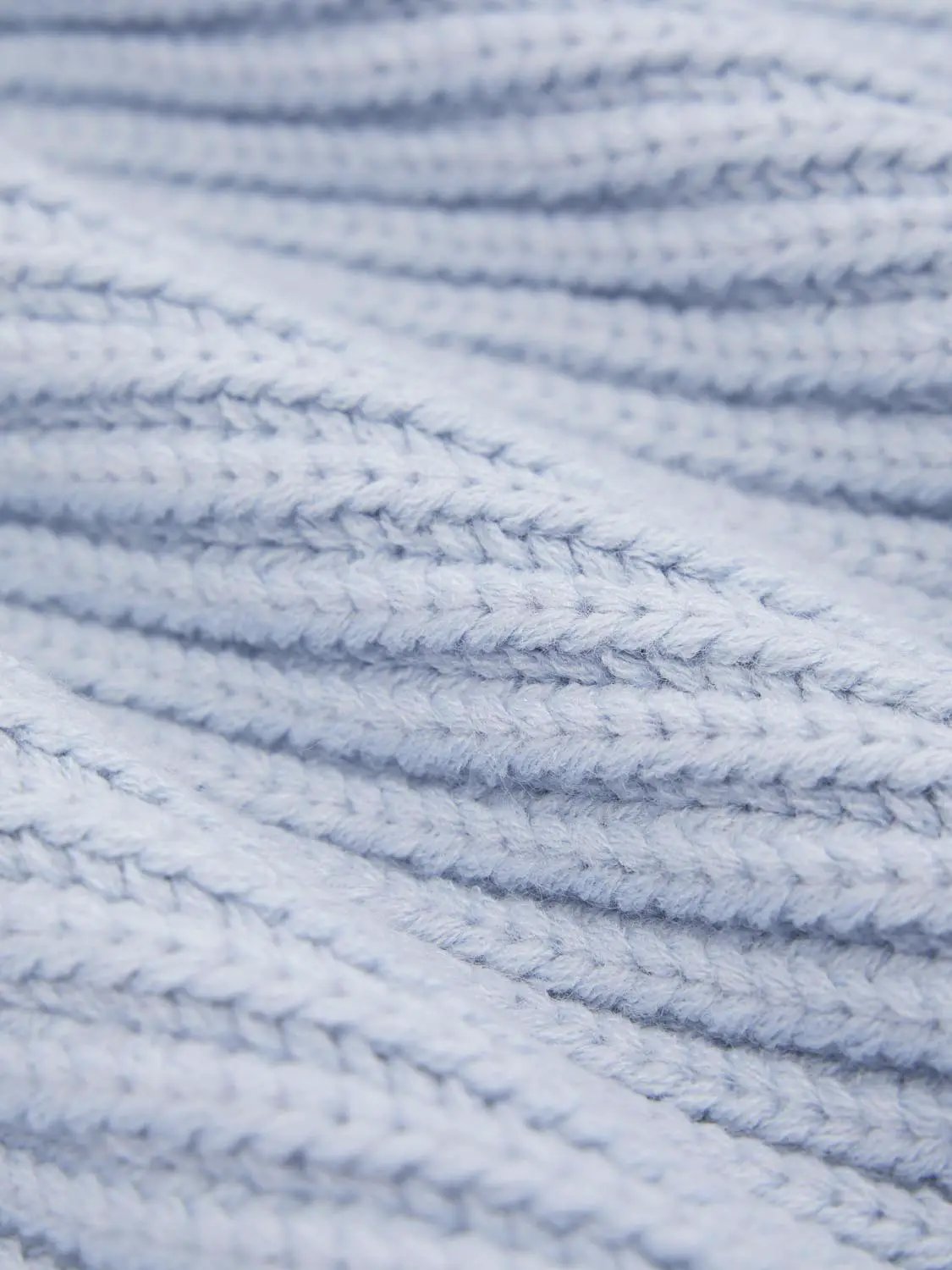 Loose V-Neck Knitted Vest in light blue knit fabric with close-up texture