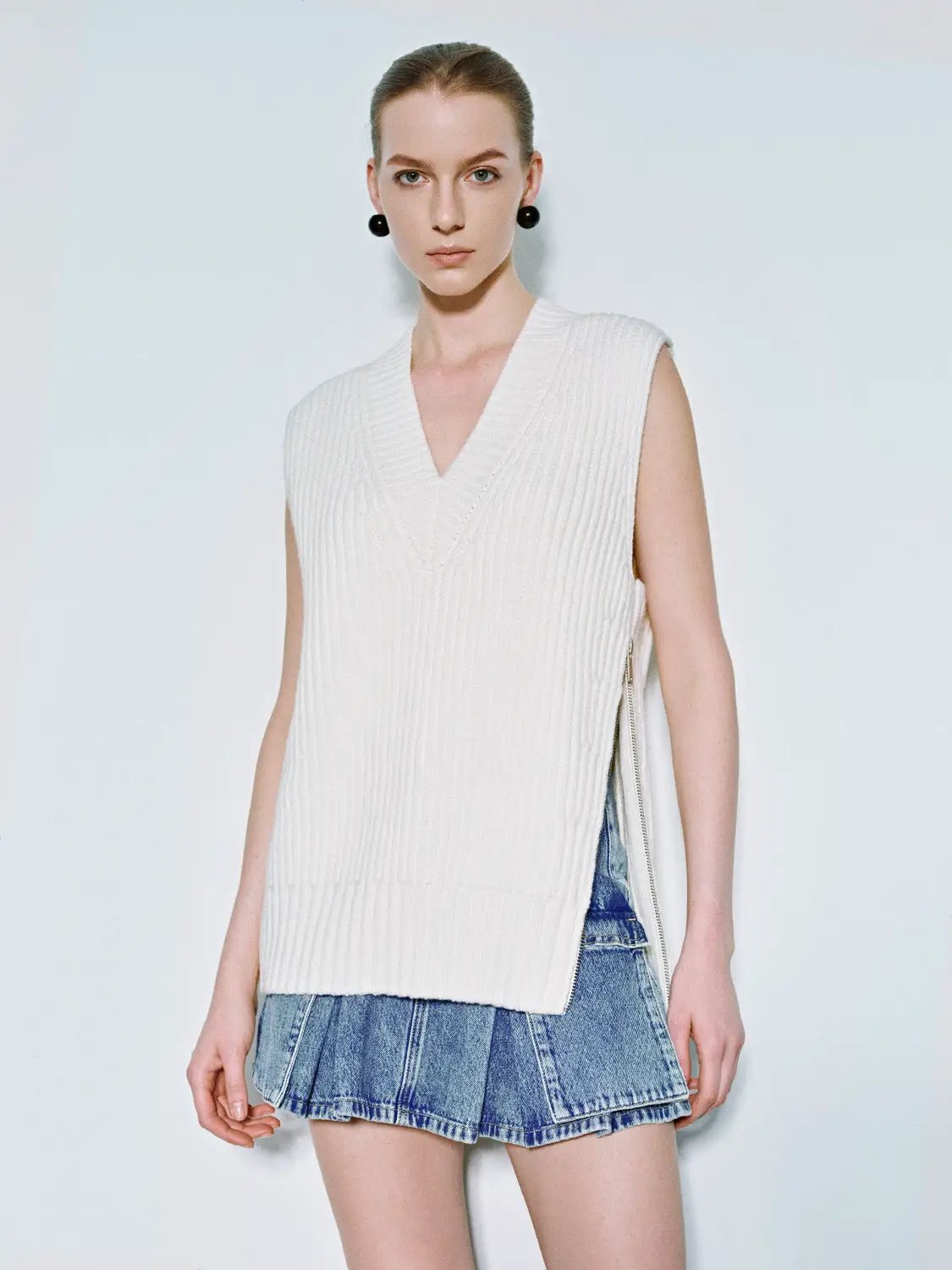 Loose V-Neck Knitted Vest in white by Urban Revivo Fashion; sleeveless ribbed knit with side zipper.