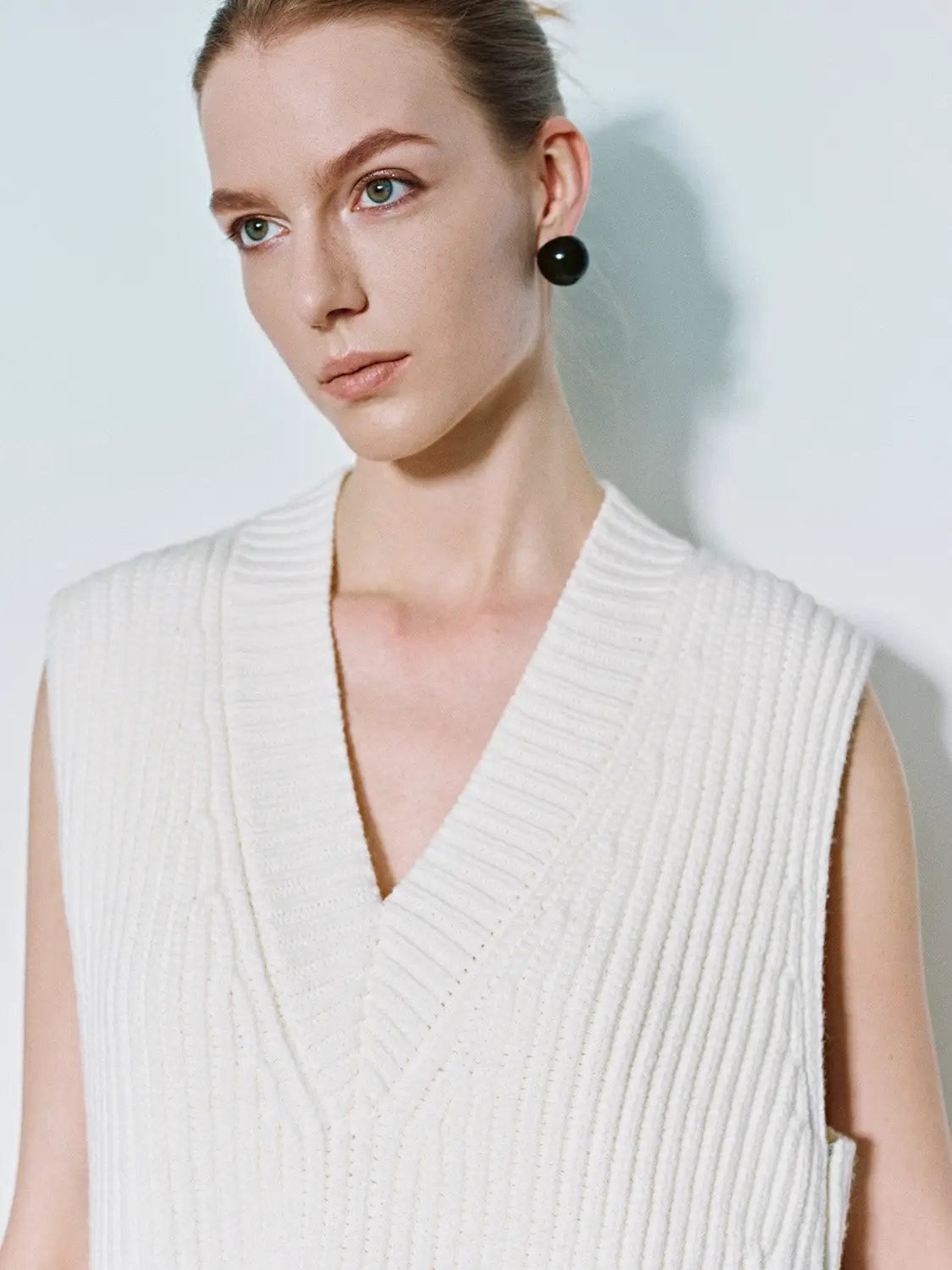 Loose V-Neck Knitted Vest in white with a ribbed knit texture, sleeveless