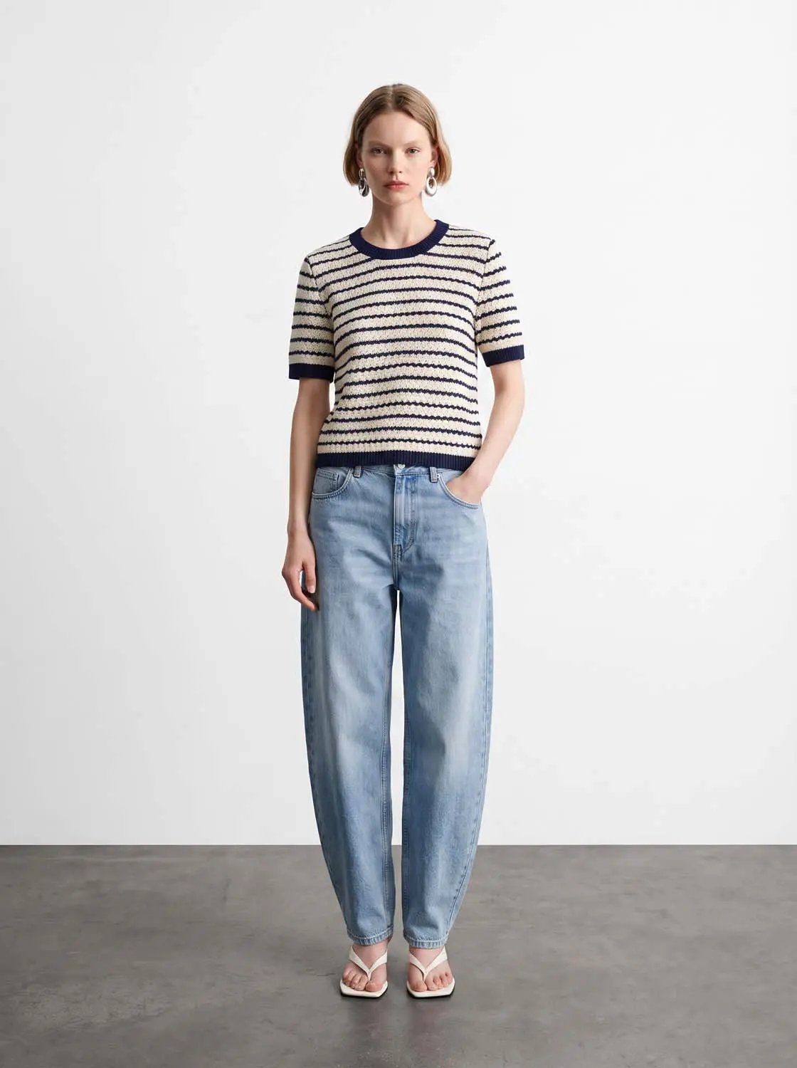 Cotton striped textured knit T-shirt with navy rib trim; cream with navy stripes, short sleeves.