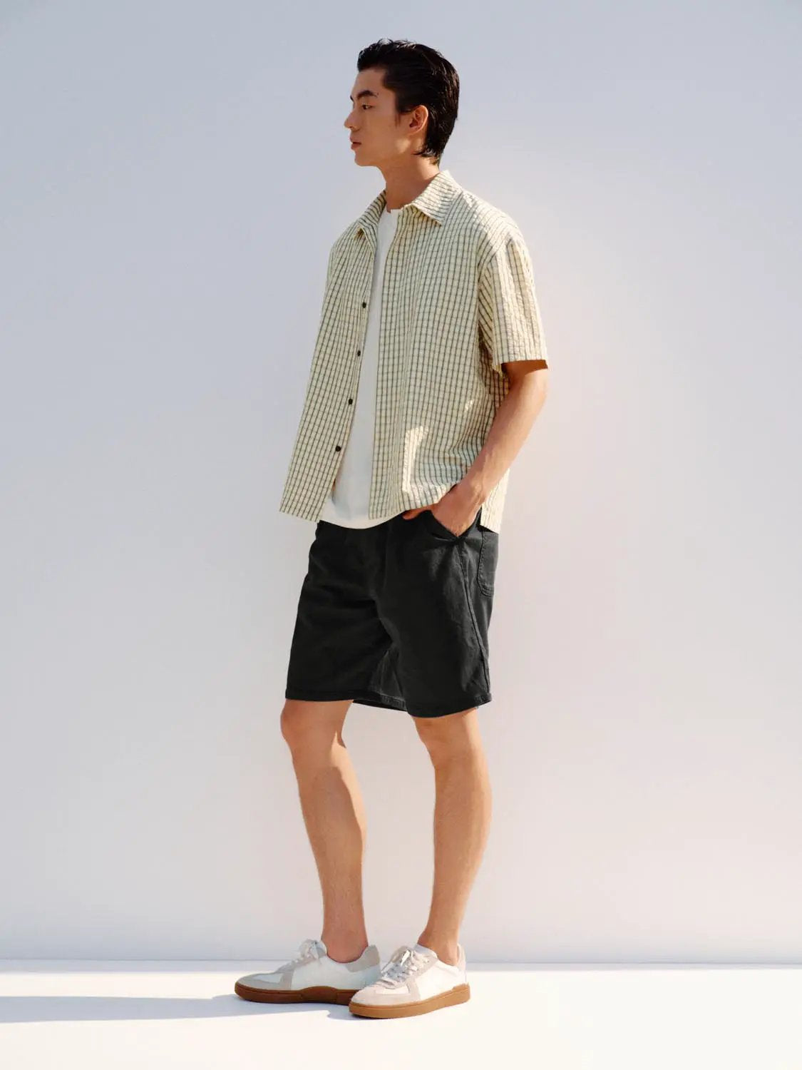 Button-front shirt, beige checkered pattern, short-sleeve men's casual shirt.