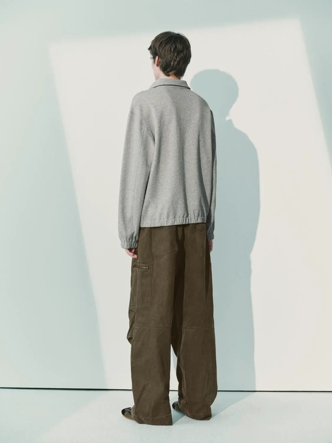Sweatshirts light gray pullover with elastic cuffs and hem, back view.