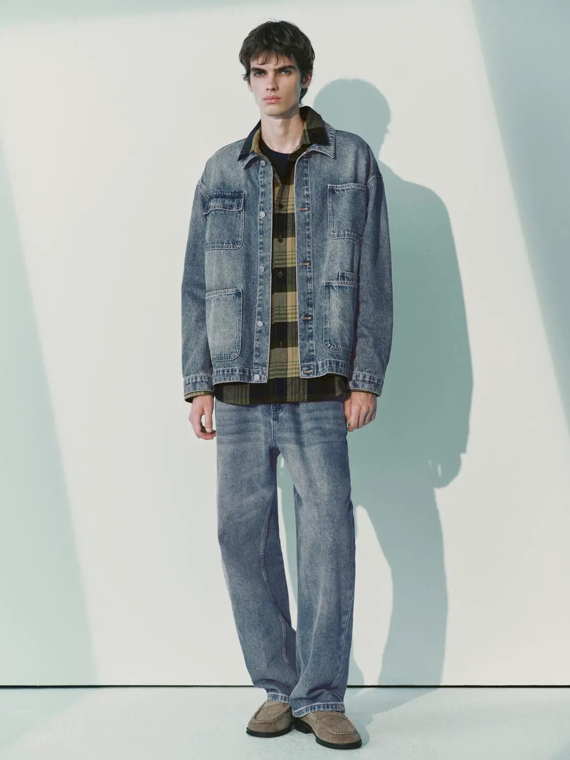 Denim jacket in light blue wash with front chest and lower pockets, metal buttons