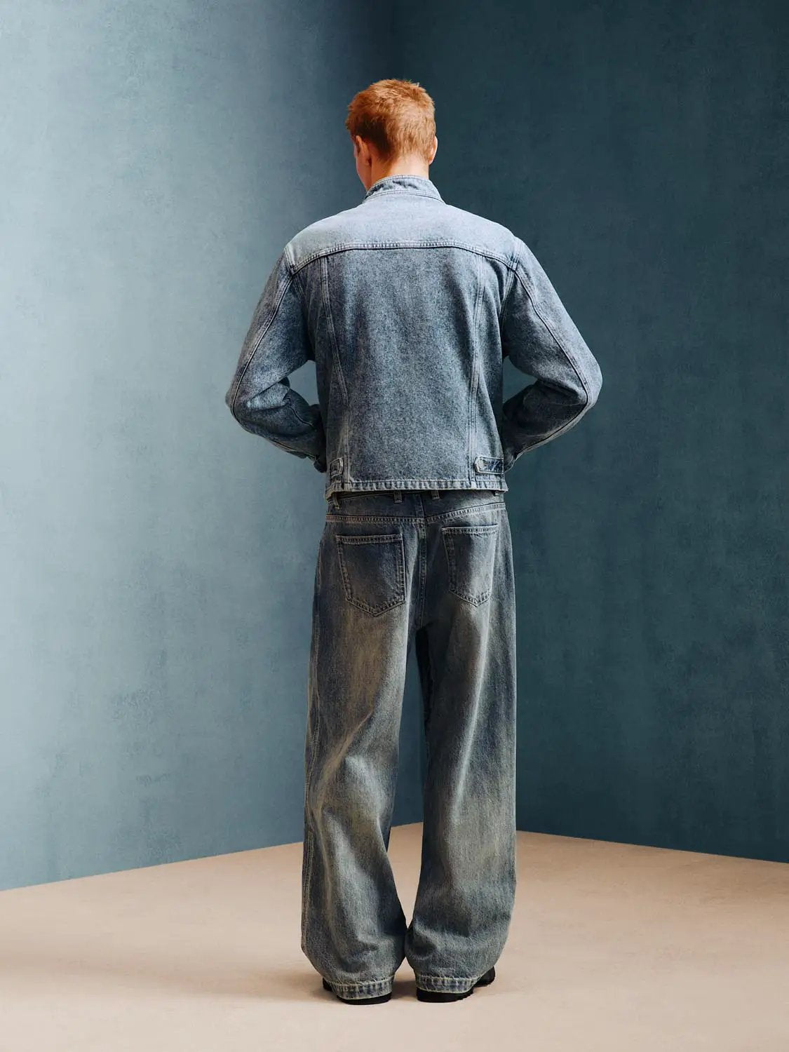 Jeans and denim jacket by Urban Revivo Fashion, blue denim, back view.