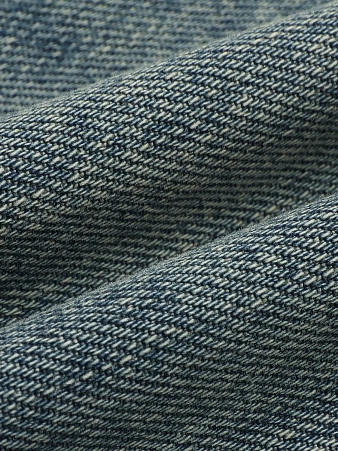 Jeans blue denim fabric close-up texture with visible twill weave detail