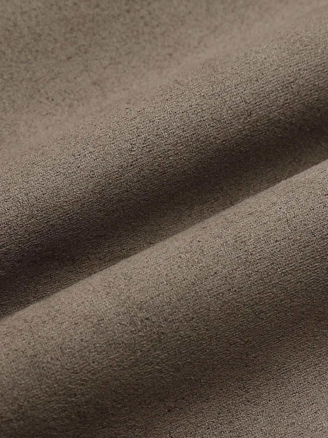 Jacket fabric close-up in brown suede-like material