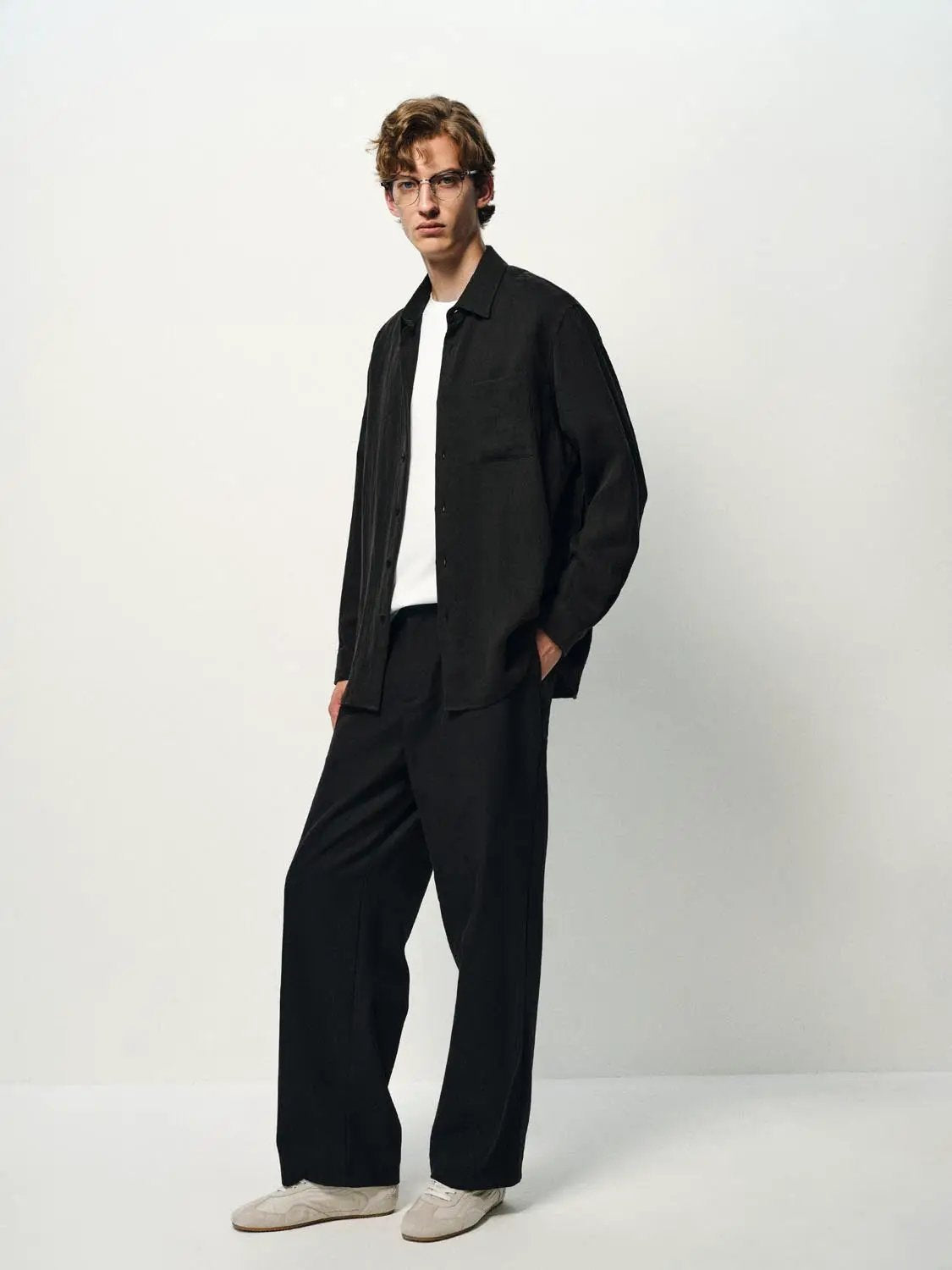Cardigan shirt in black by Urban Revivo Fashion; model wearing over white tee.