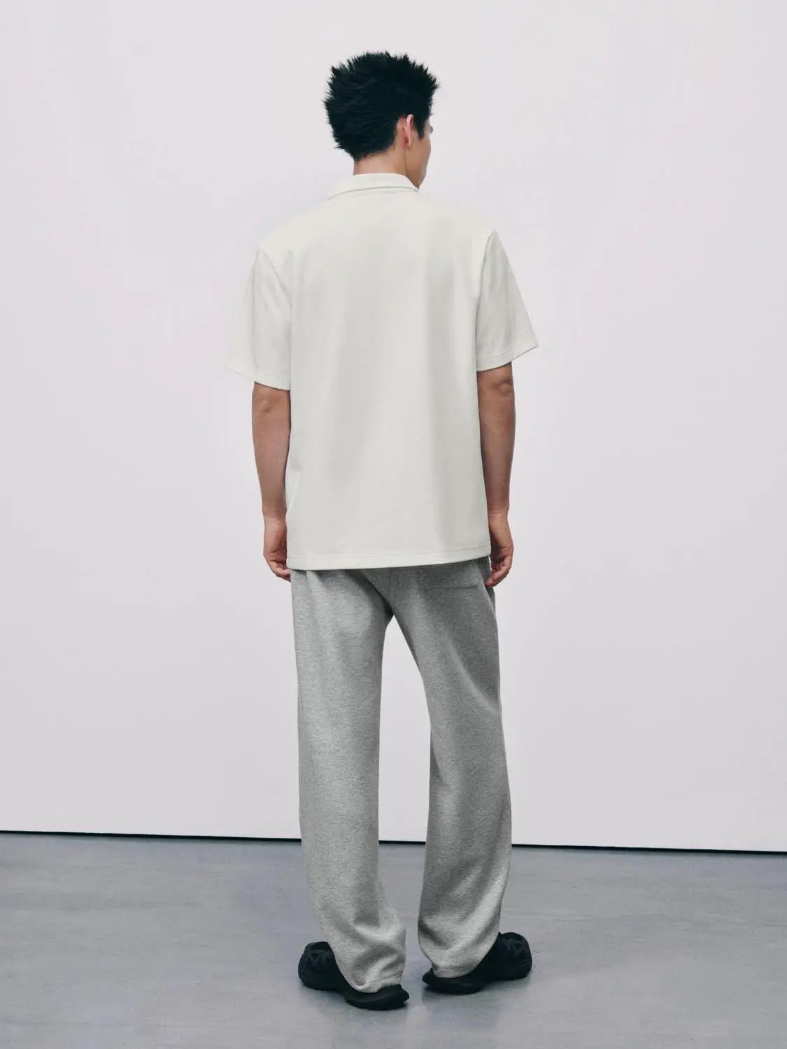 Textured Brushed Polo Cotton-Blend Shirt in light off-white, short-sleeve polo worn by model (back view).