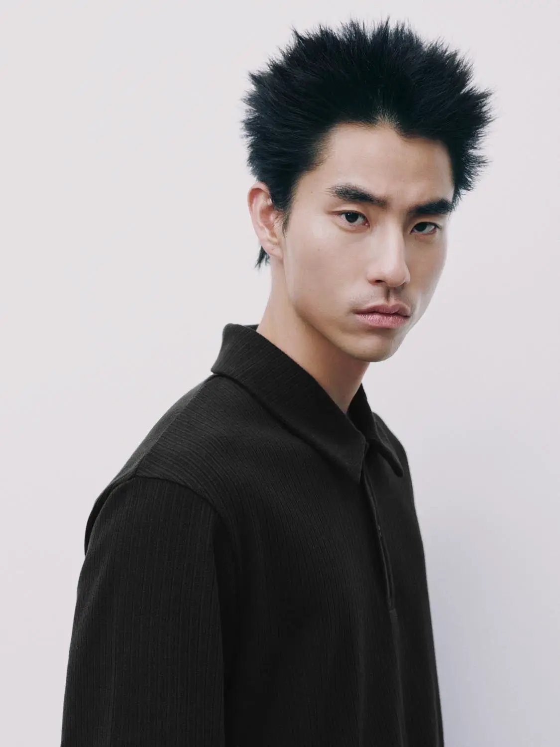 Polo shirt in black ribbed fabric worn by male model