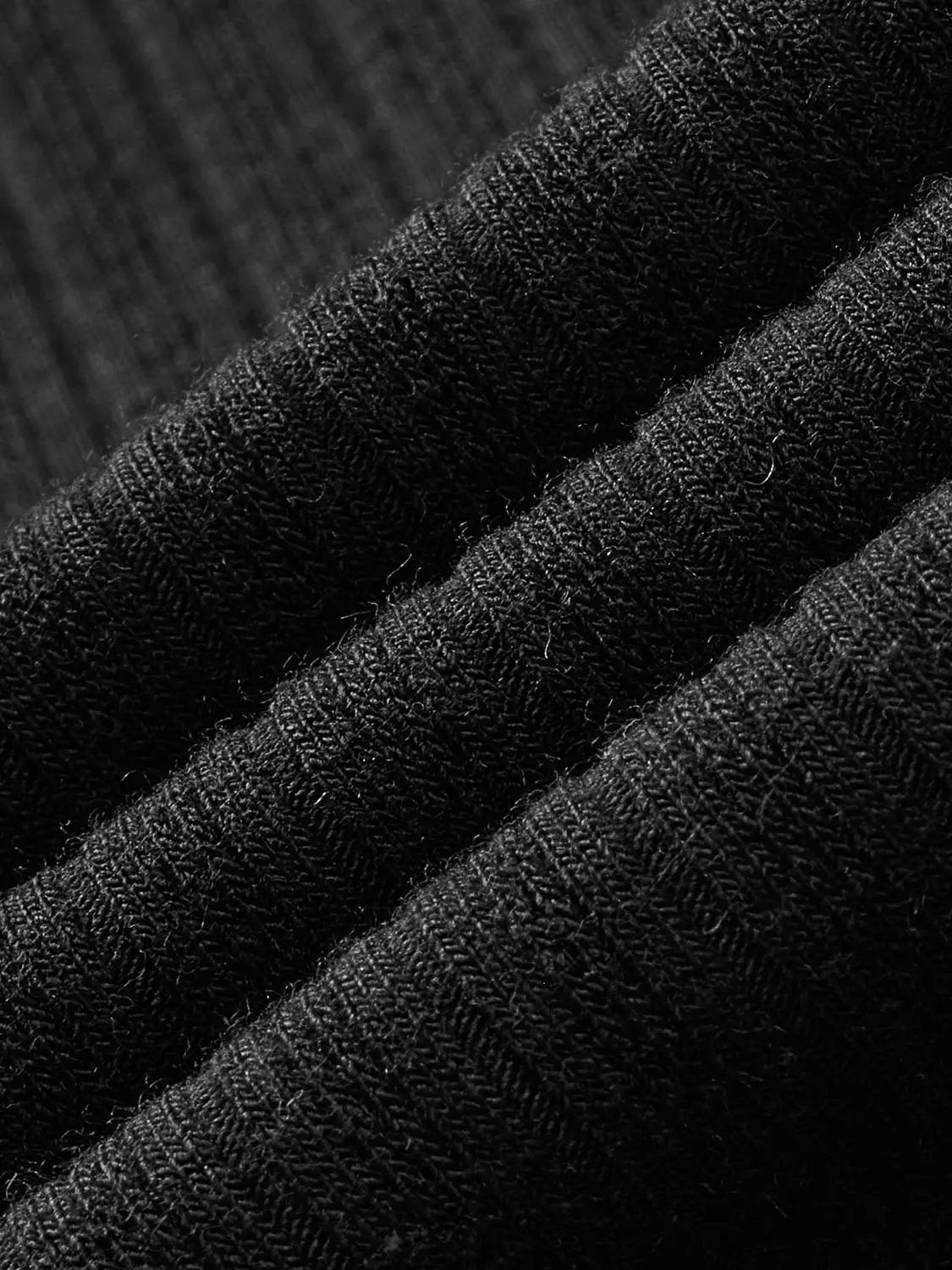Polo shirt fabric close-up in black textured knit fabric