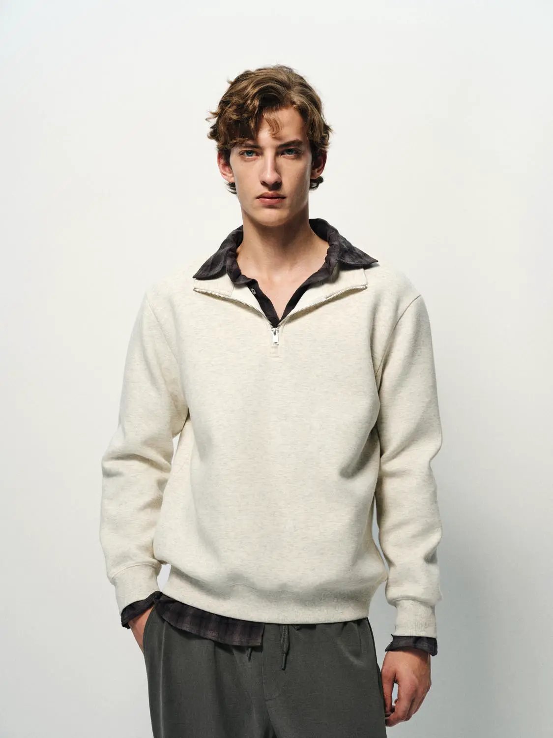 Sweatshirt cream fleece pullover with quarter-zip neckline.