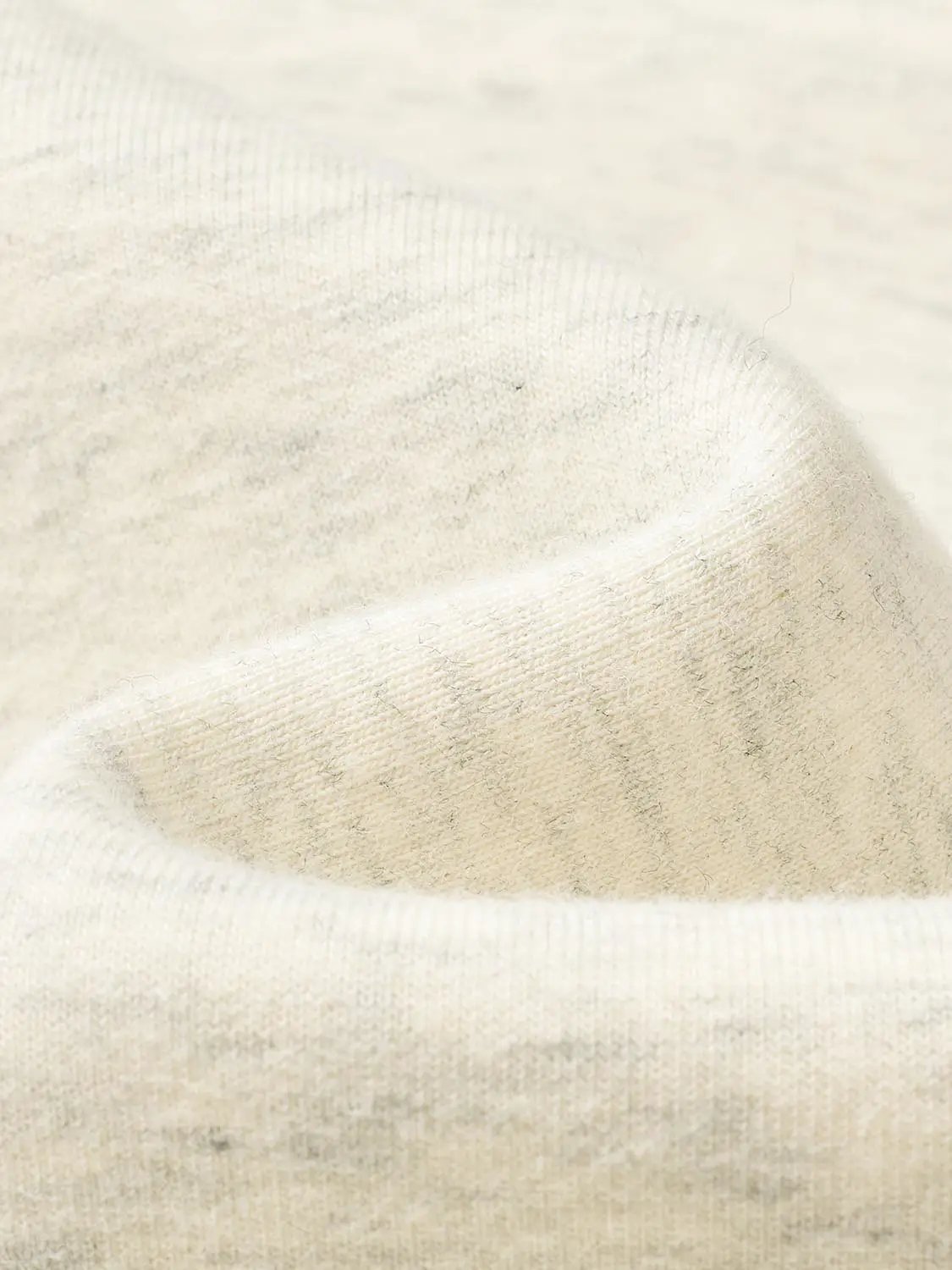 Cream knit sweatshirt fabric close-up with soft texture