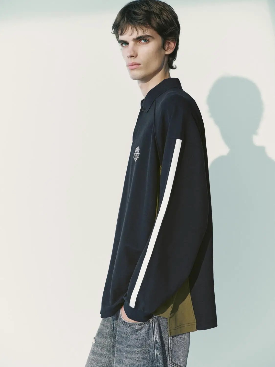 Polo shirt by Urban Revivo Fashion in navy long-sleeve with white stripe on sleeve and chest logo.