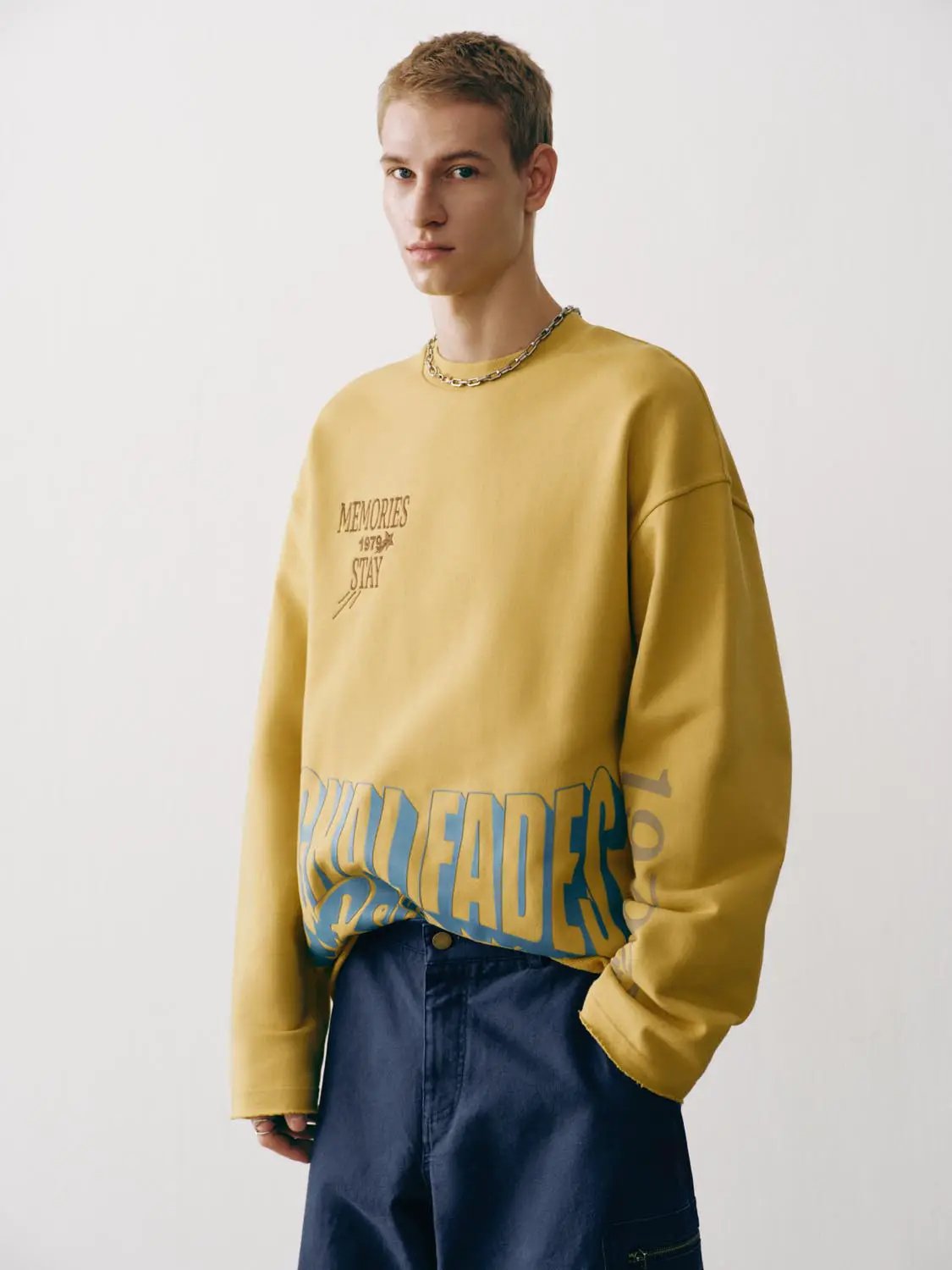 Sweatshirt by Urban Revivo Fashion in mustard yellow with blue graphic text at hem, long-sleeve.