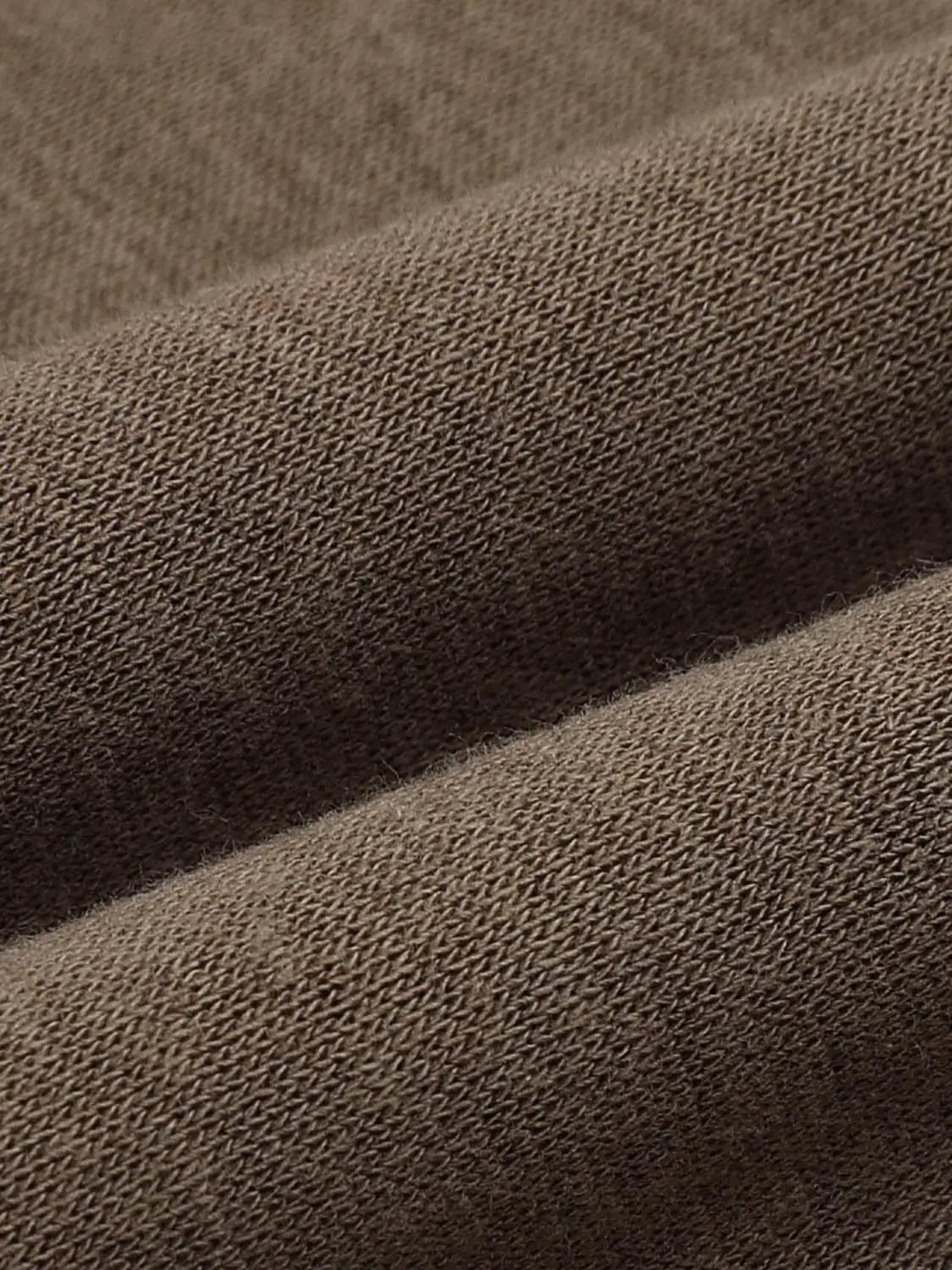 Sweatshirt fabric close-up in brown knit texture detail.