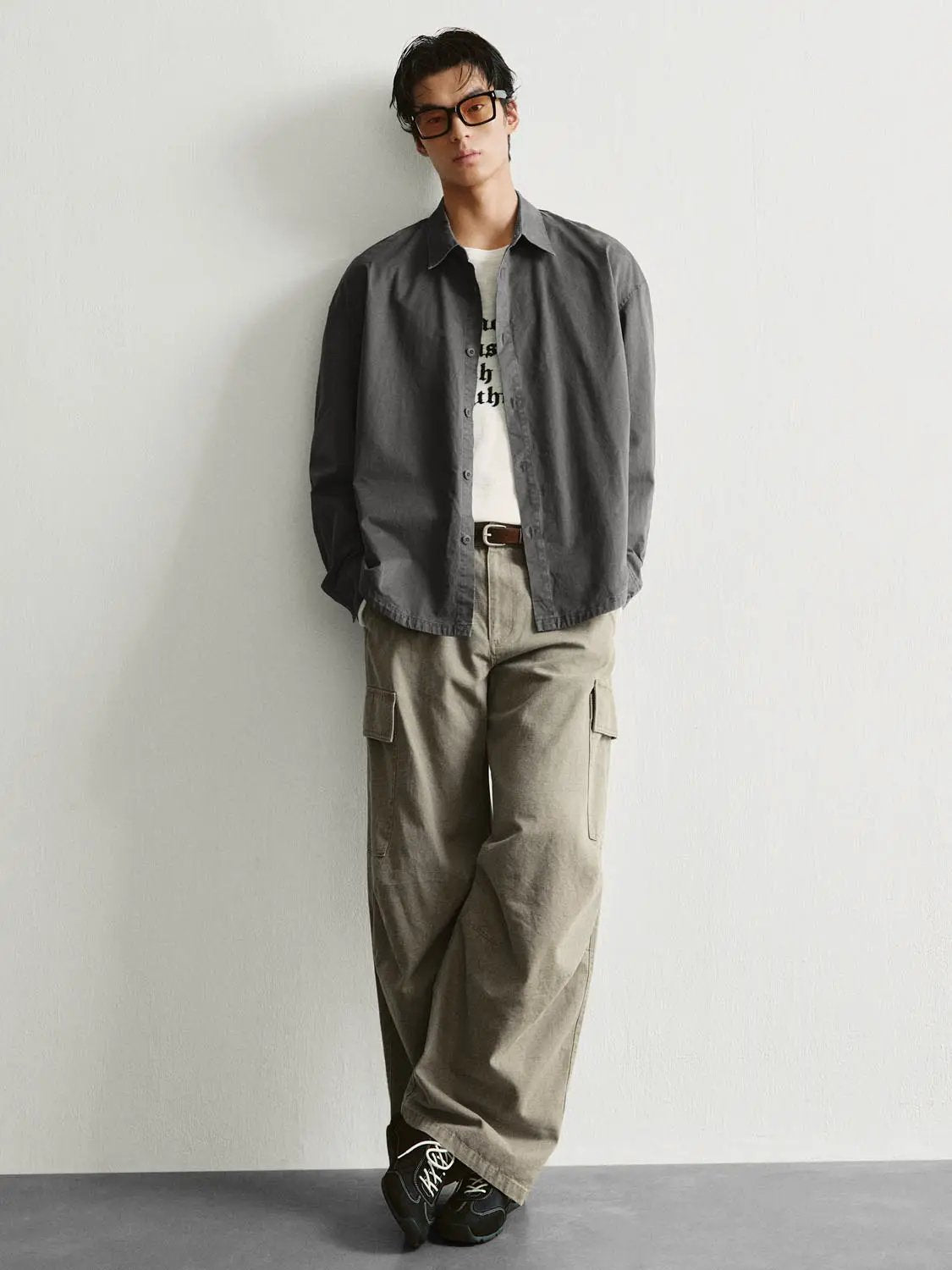 Button-front shirt by Urban Revivo Fashion in charcoal gray, worn open over a white tee with beige cargo pants.
