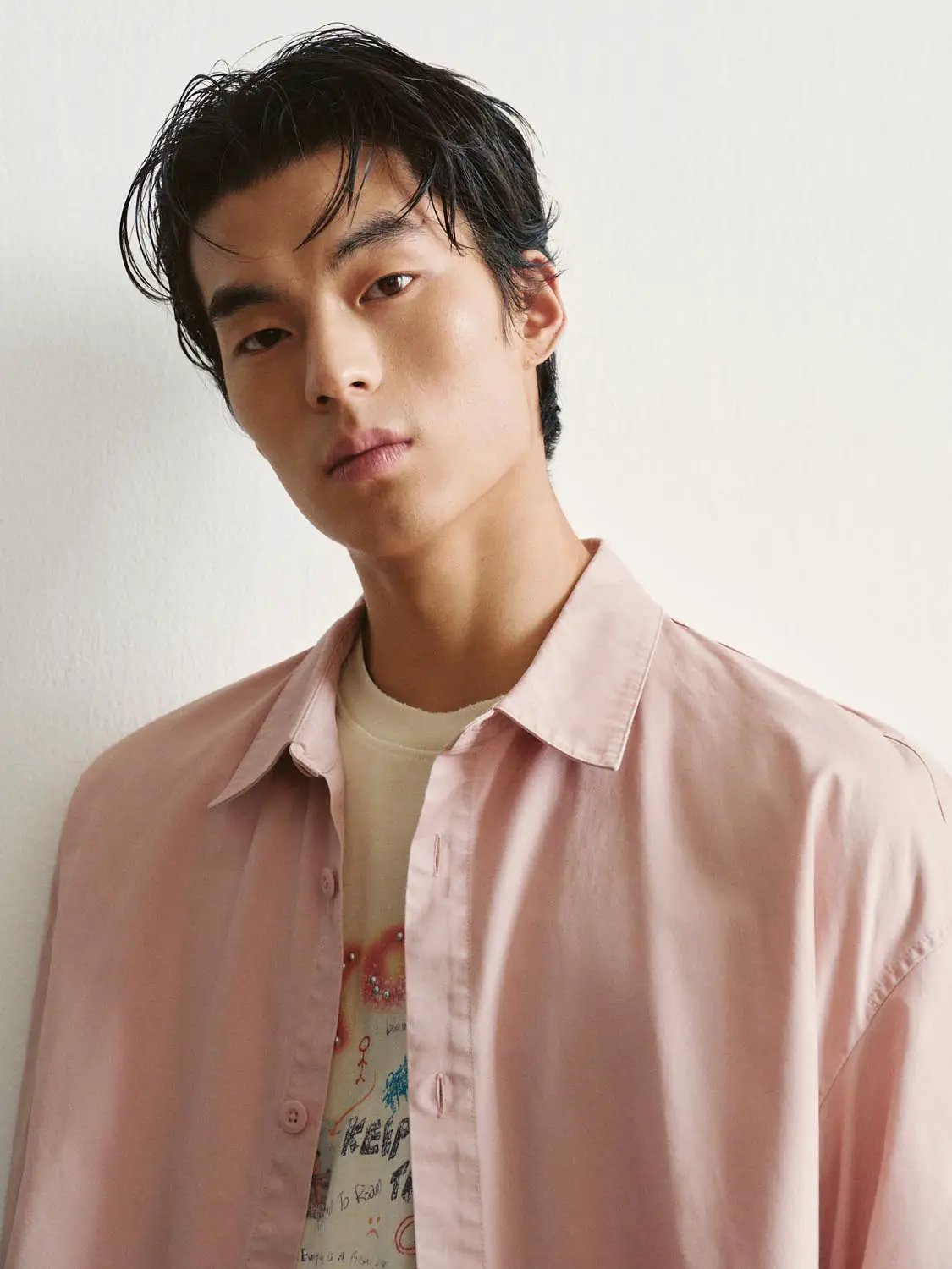 Button-front Shirt in pink worn open over beige graphic tee