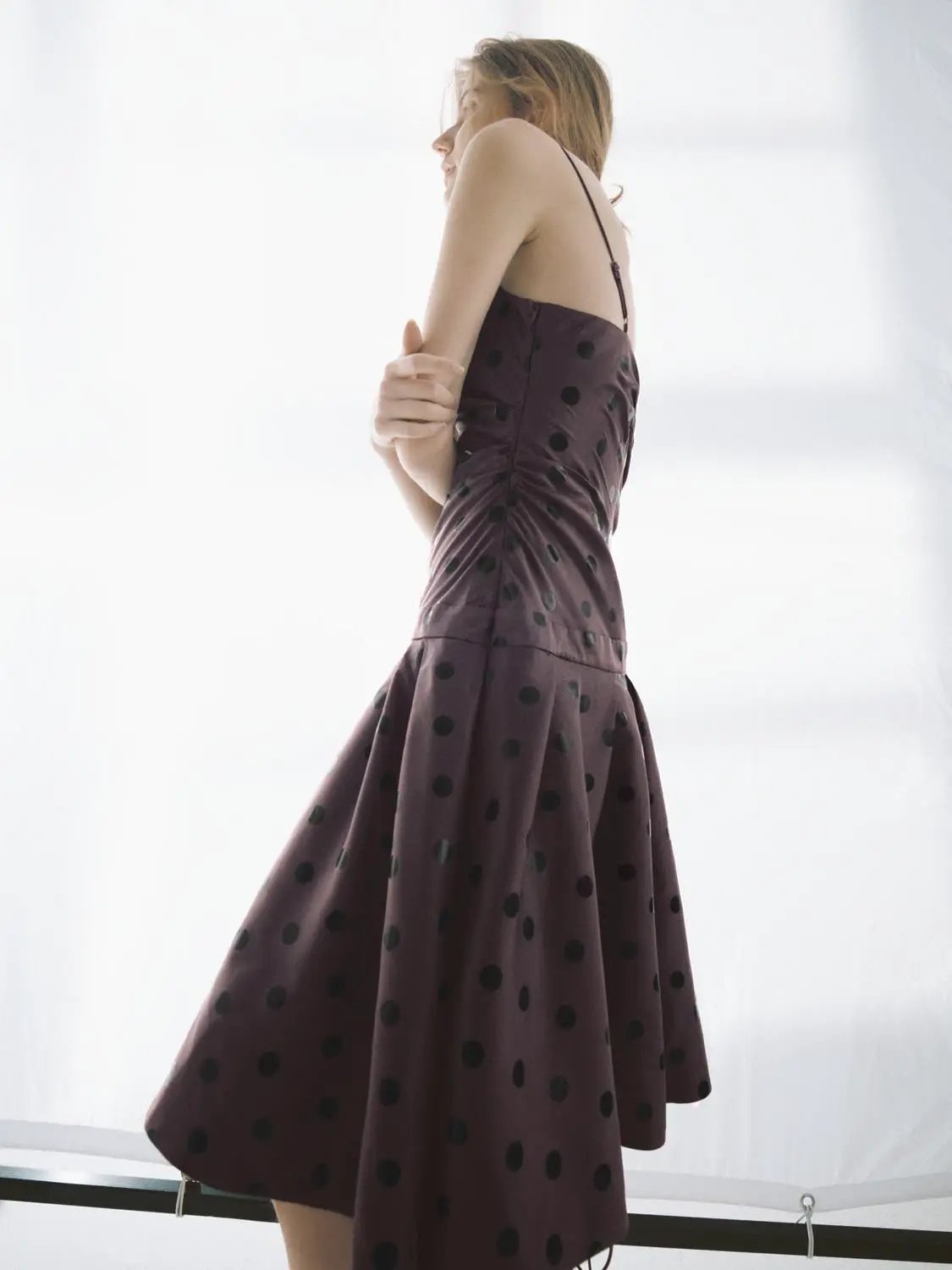 A-Line dress in burgundy with black polka dots, spaghetti straps, knee-length.