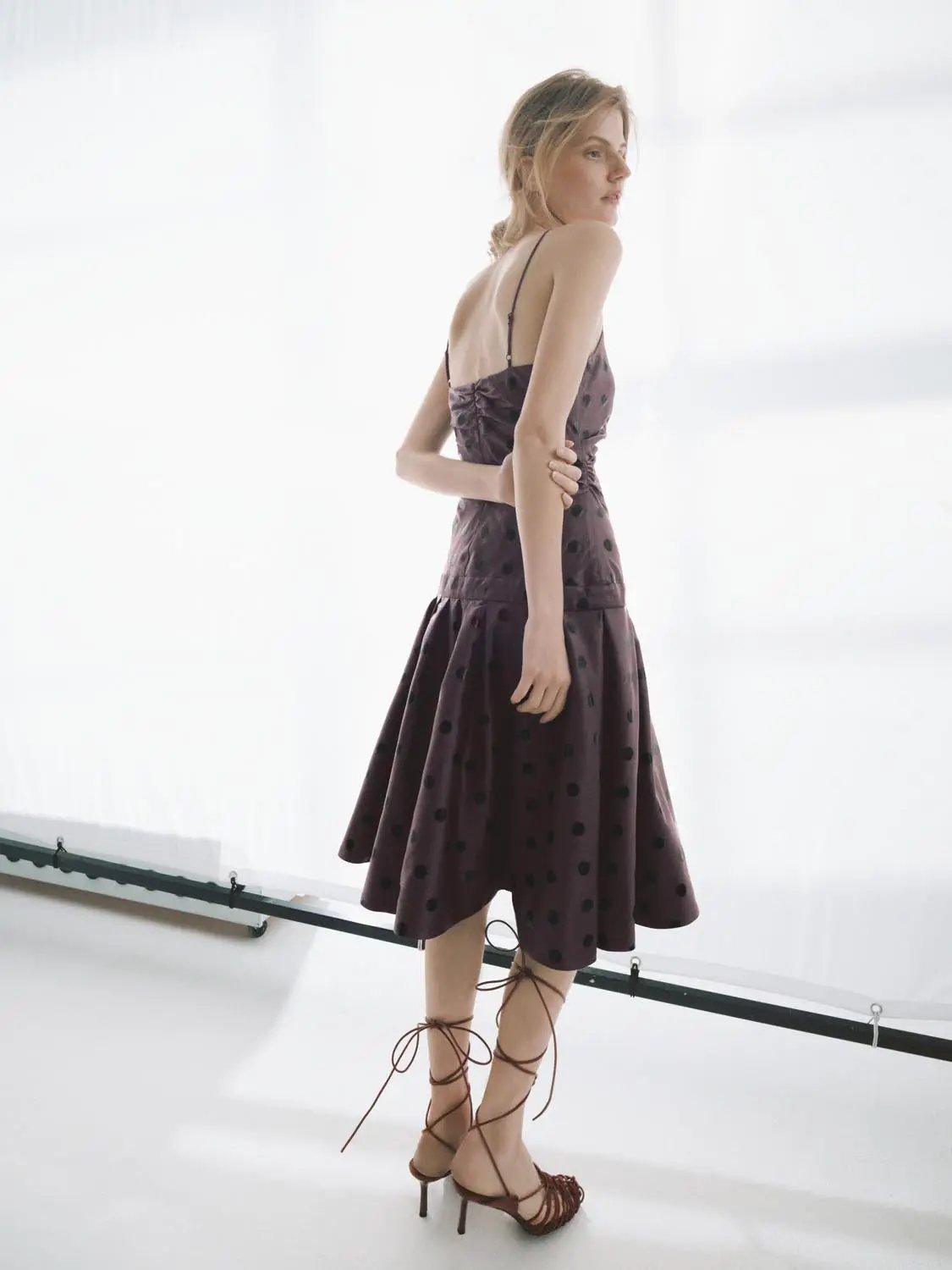 A-Line dress in plum with black polka dots, ruched bodice, spaghetti straps, midi length.