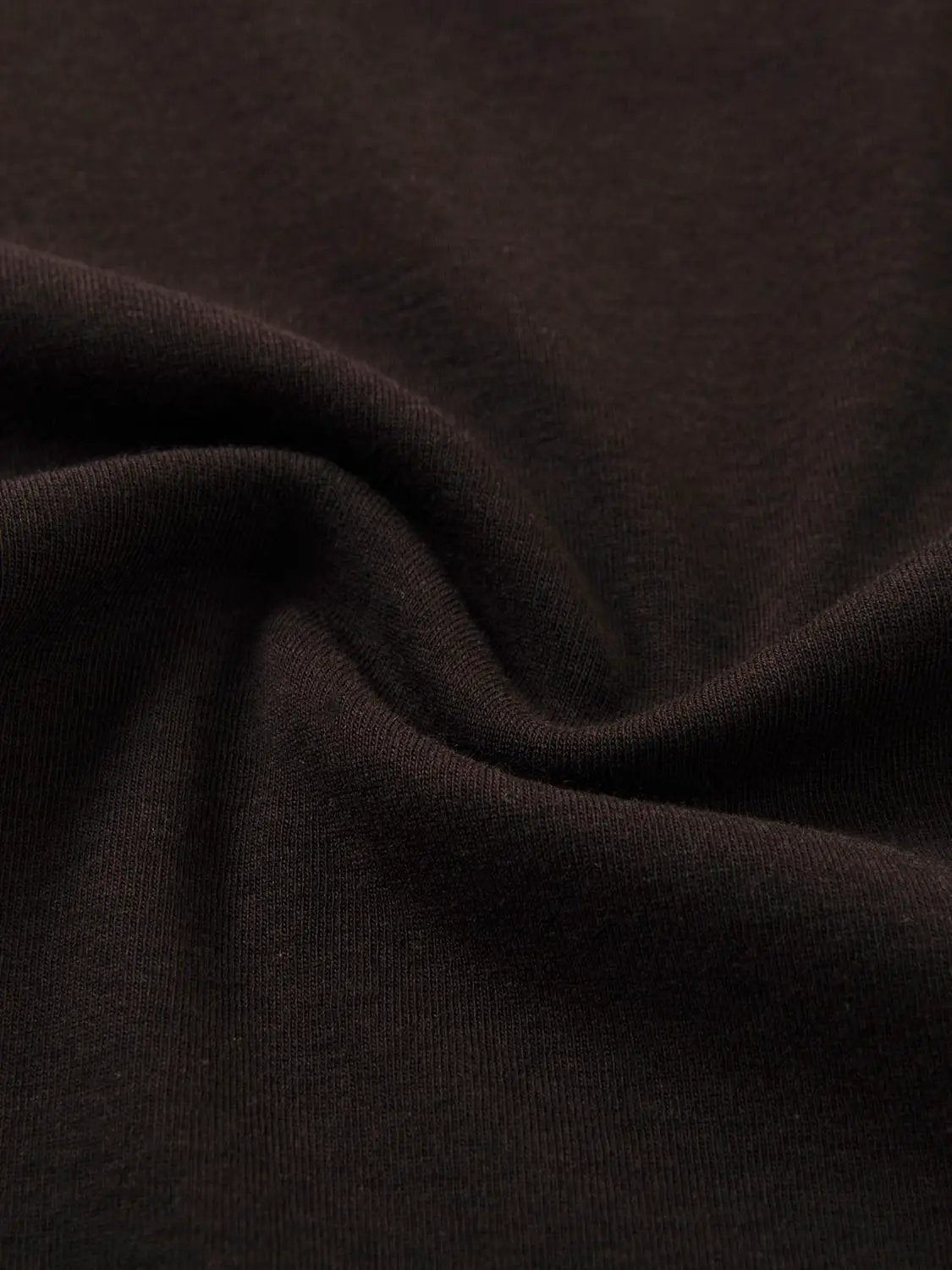 Tank top fabric close-up in dark brown with smooth knit texture.