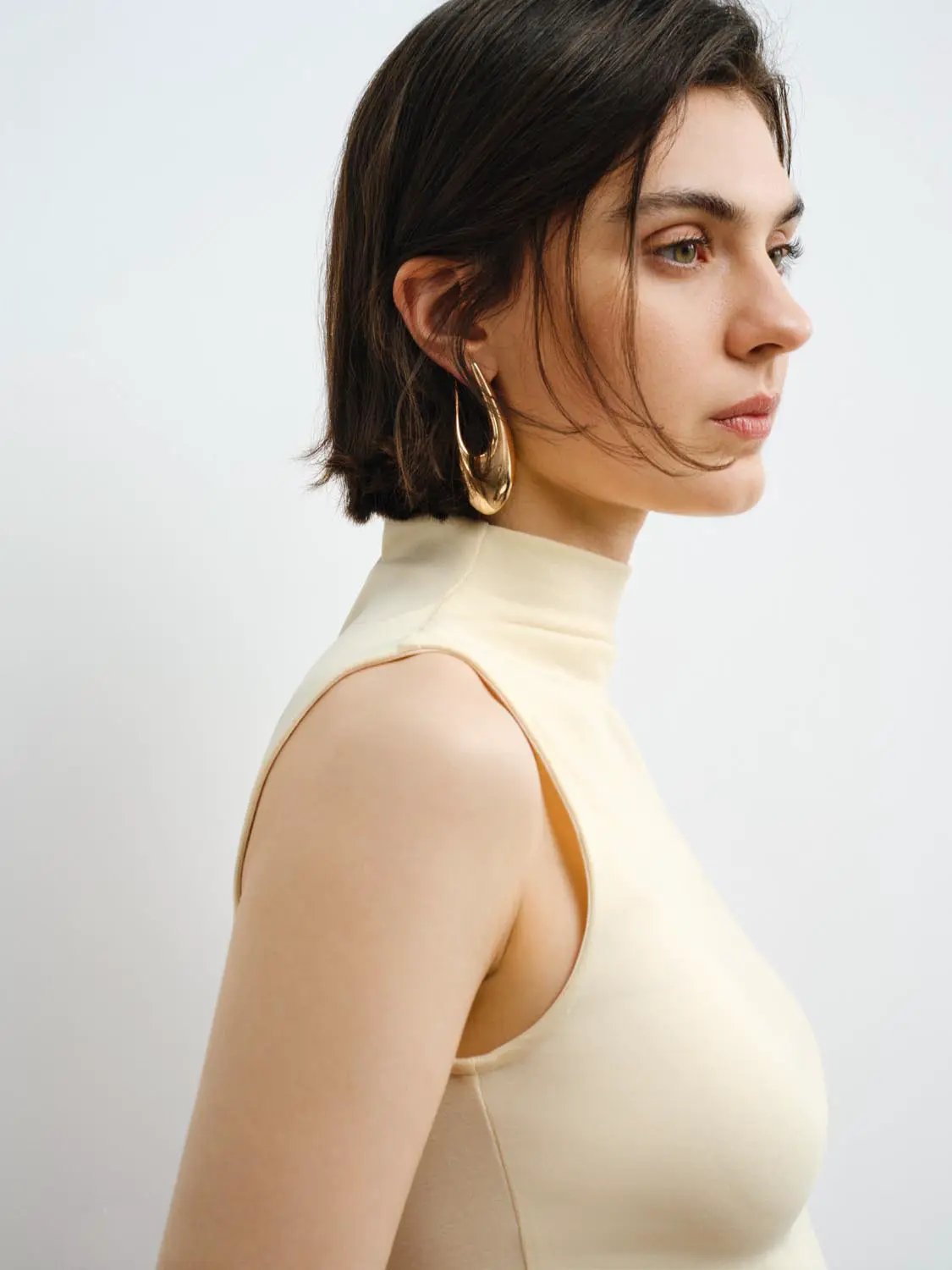Tank Top in cream-beige, sleeveless high-neck style.