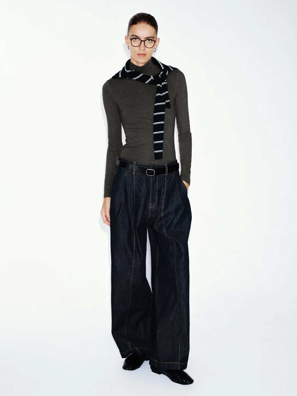 T-Shirt in dark olive knit worn by a model with dark denim wide-leg pants