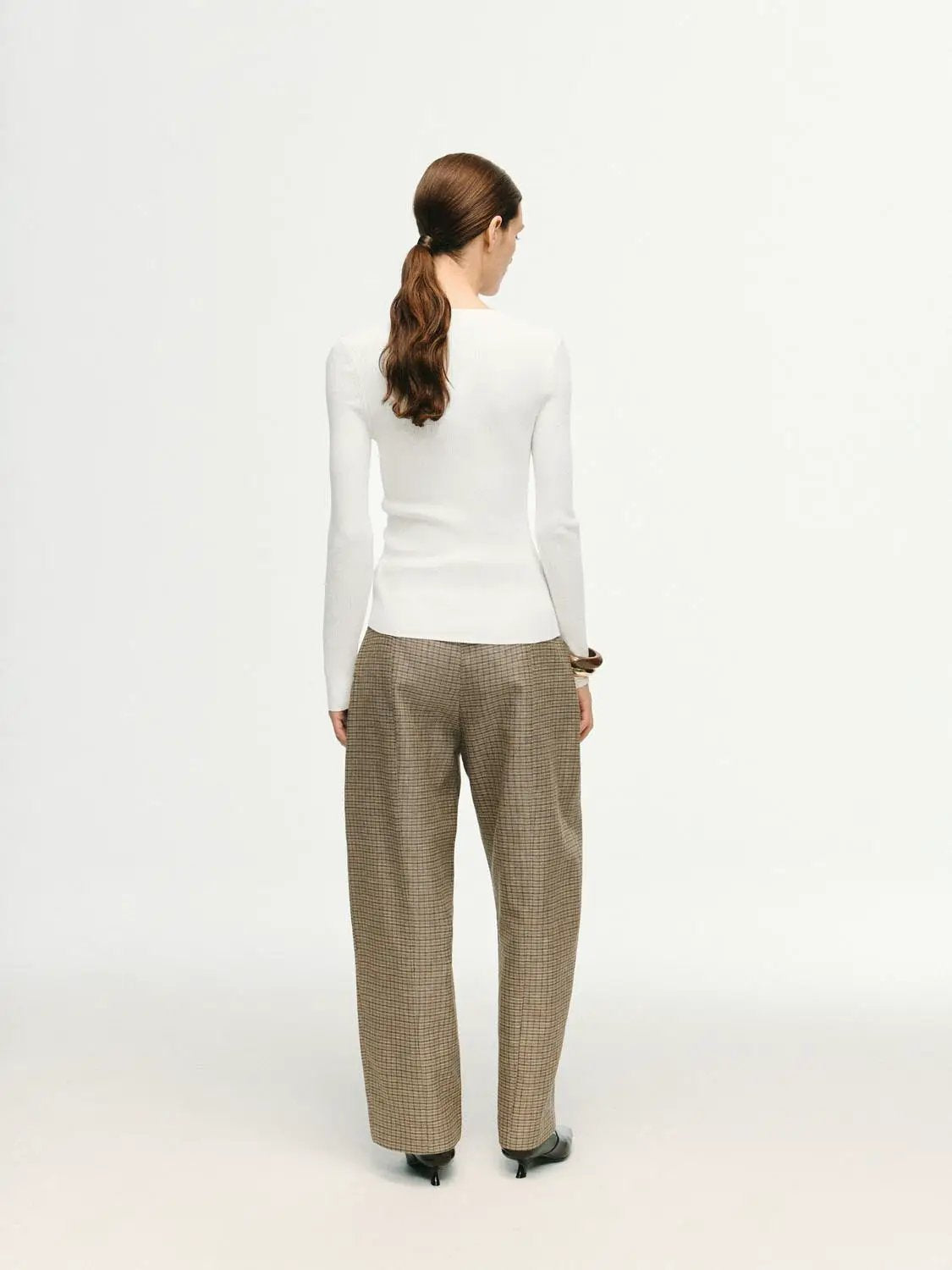 Ribbed fitted long-sleeve crew-neck knit T-shirt in white on a model.
