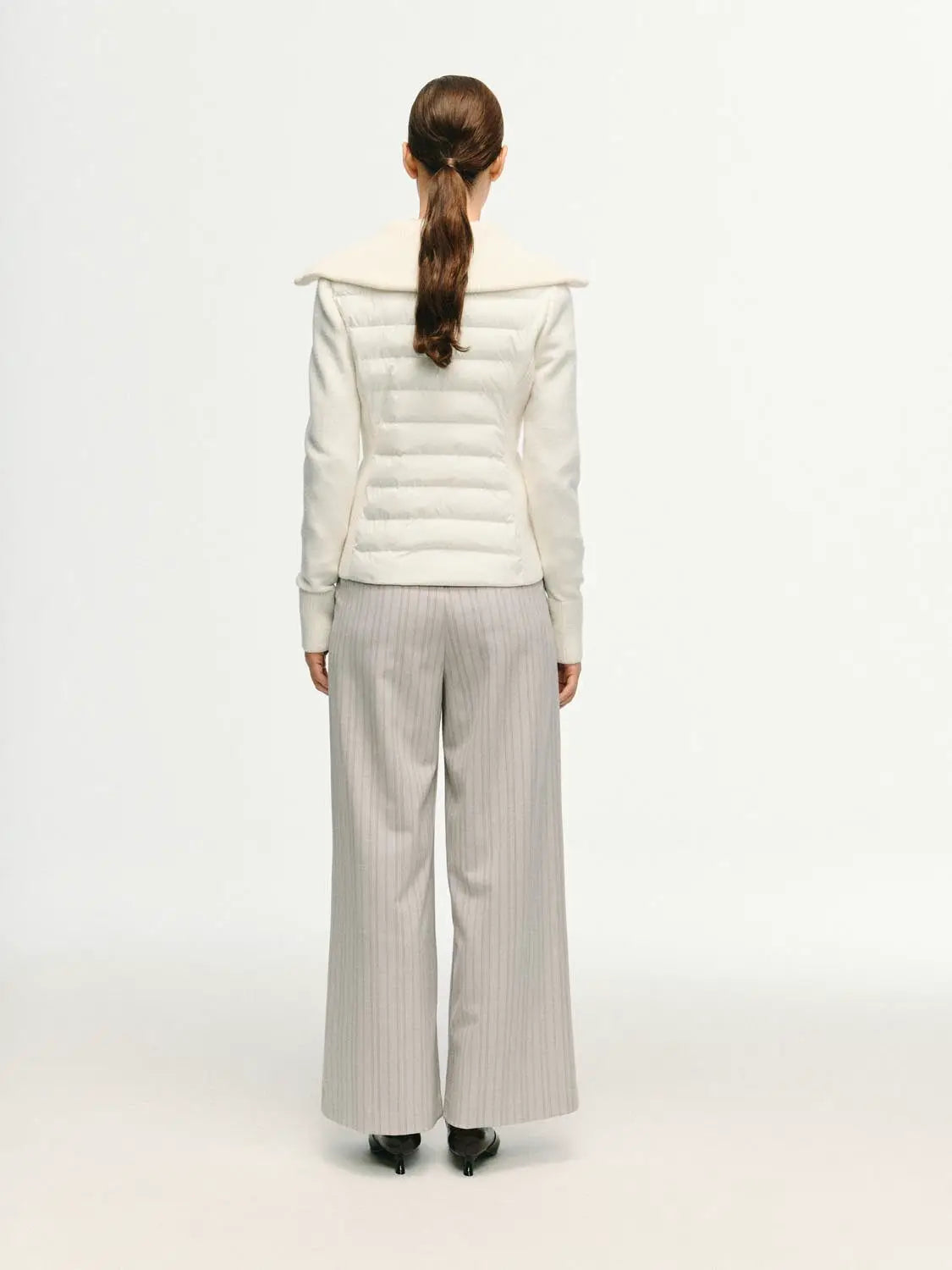 Padded Jacket white quilted with cream collar, back view of model.