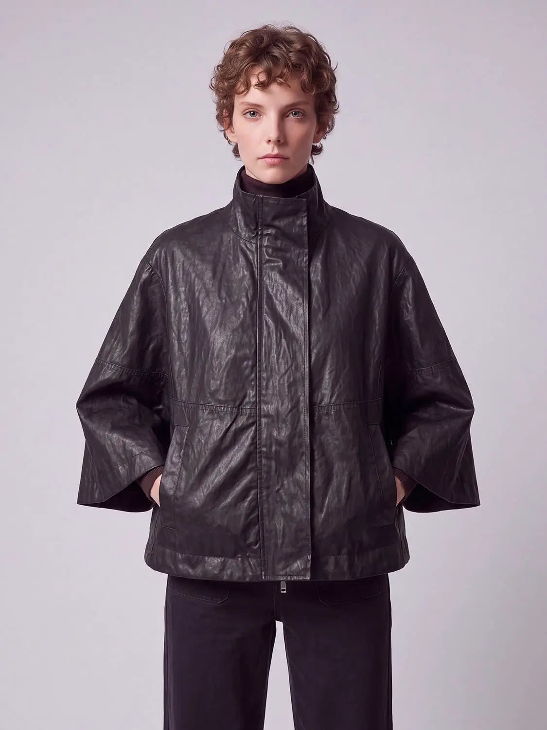 Cape poncho by Urban Revivo Fashion in black faux leather with oversized sleeves.