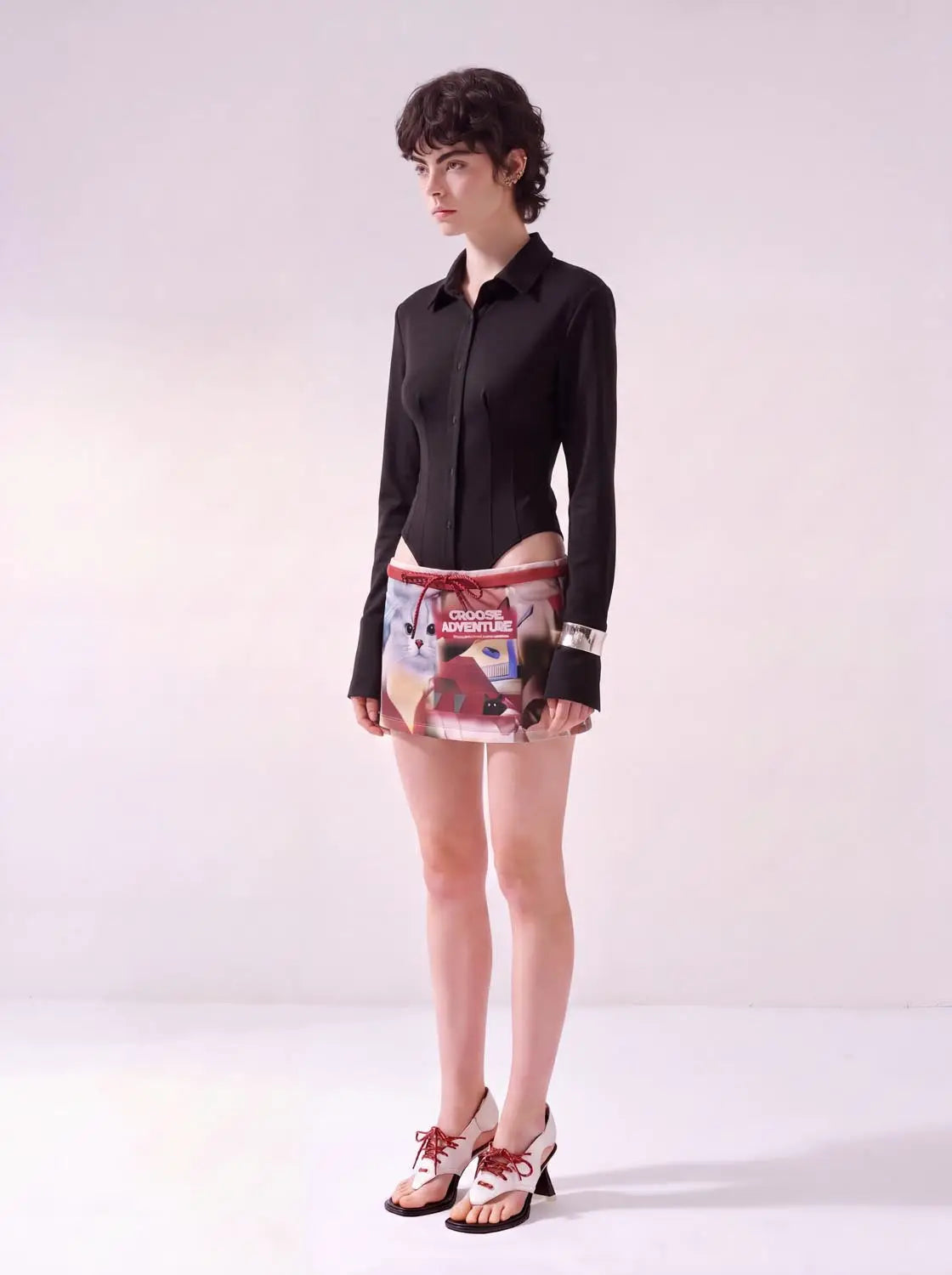 Button-front shirt, black long-sleeve, fitted on a model.