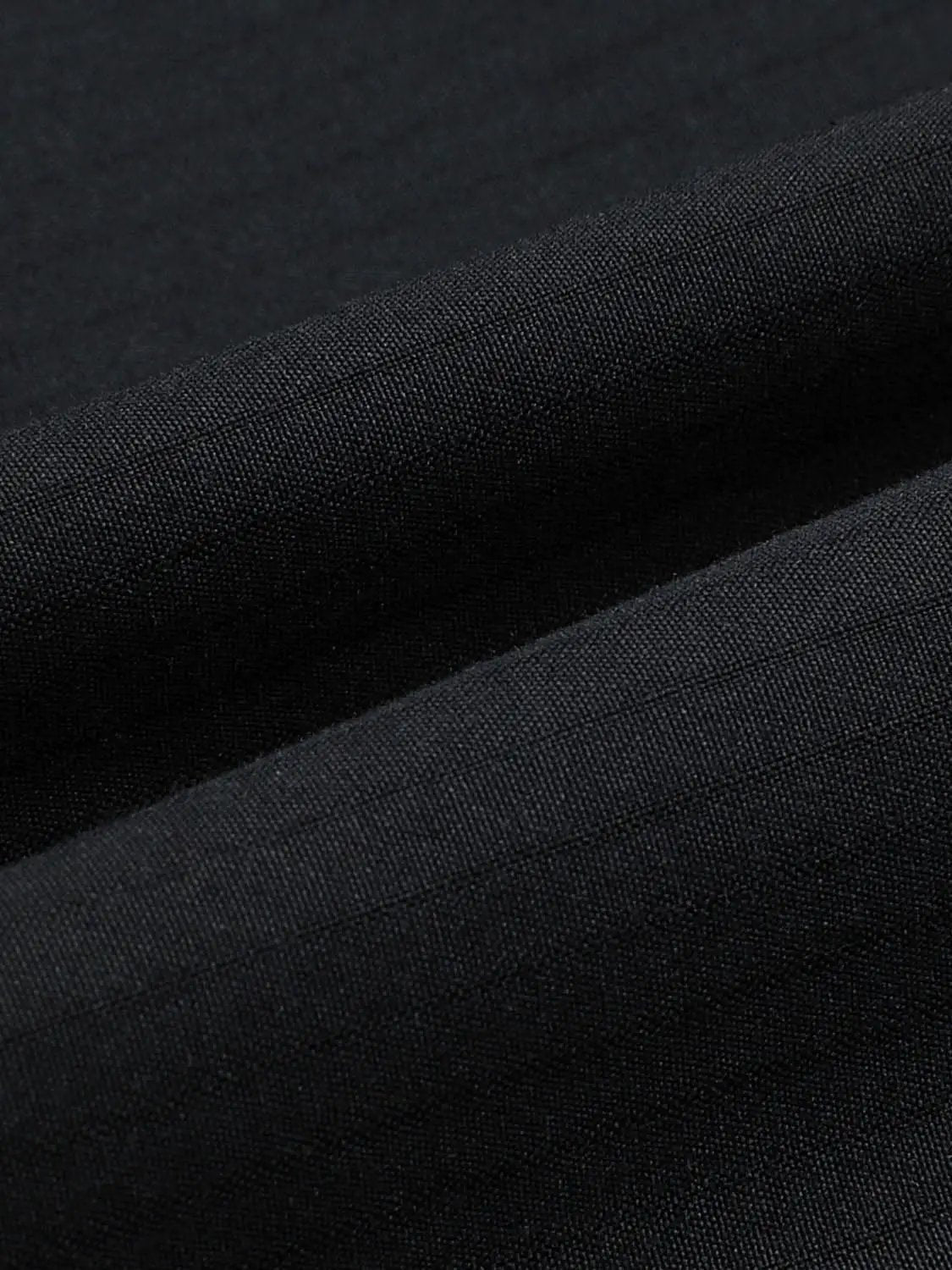 Pleated high-waisted cotton A-line skirt fabric close-up in black