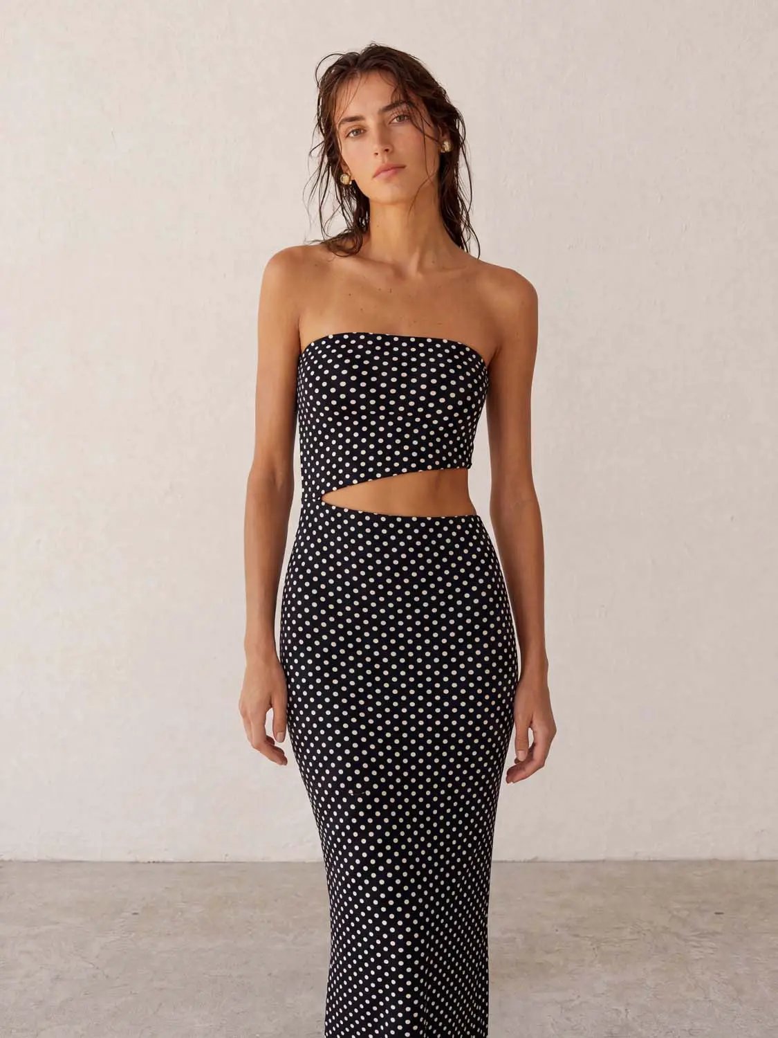 Strapless black-and-white polka-dot skinny-fit dress with waist cutout