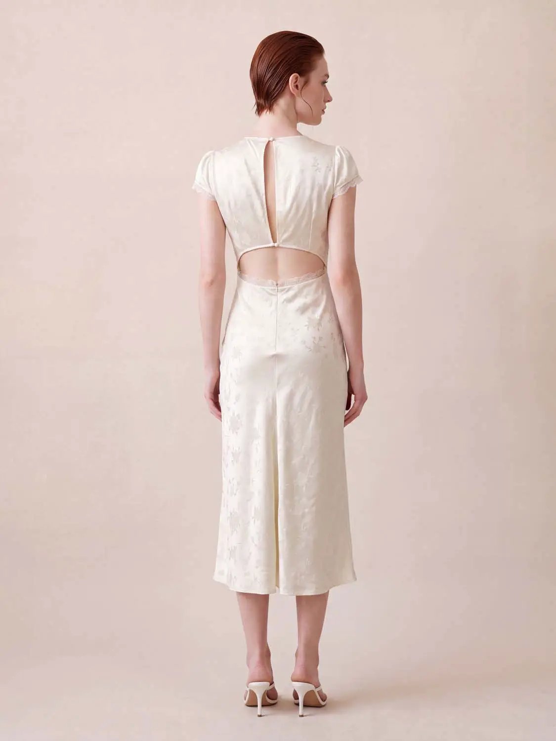 Cream floral jacquard A-line midi dress with puff sleeves, lace trim, and back cutout.
