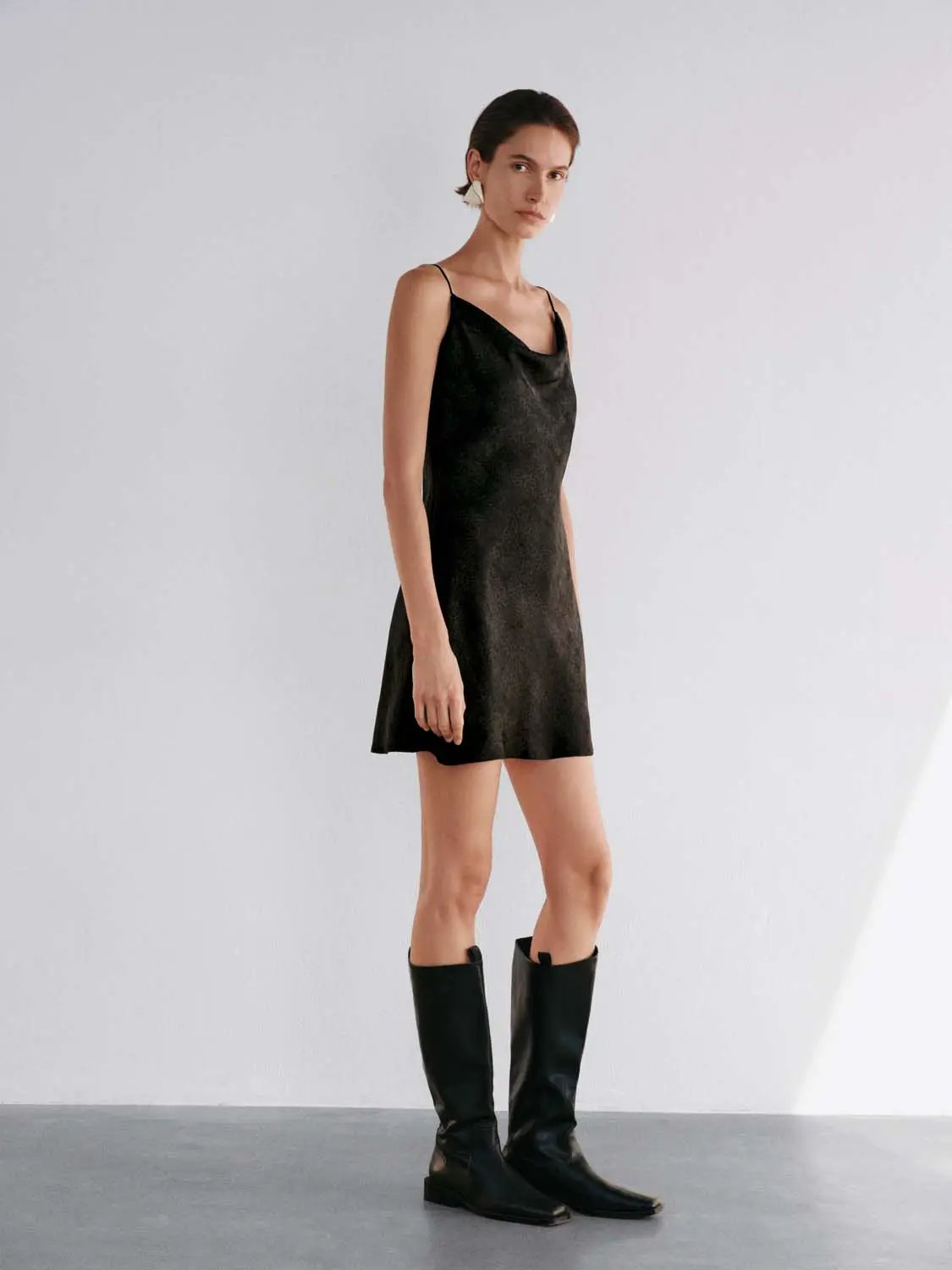 Sleeveless cowl-neck textured mini dress in black with a flared silhouette; Urban Revivo Fashion.