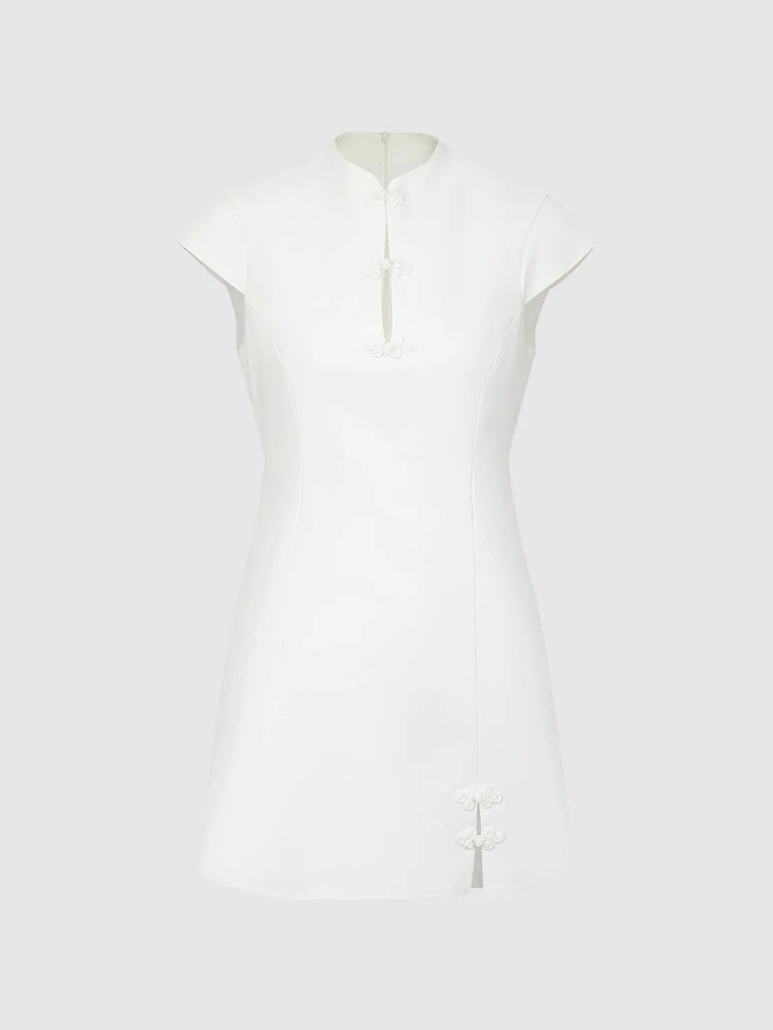 H-line Dress in white with Mandarin collar and frog closures along the placket; knee-length with a hem slit