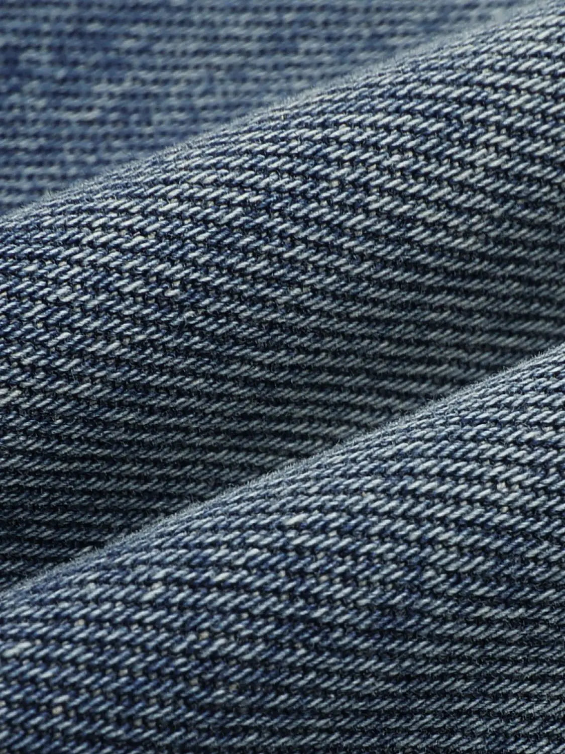 Jeans close-up in blue denim with twill weave texture