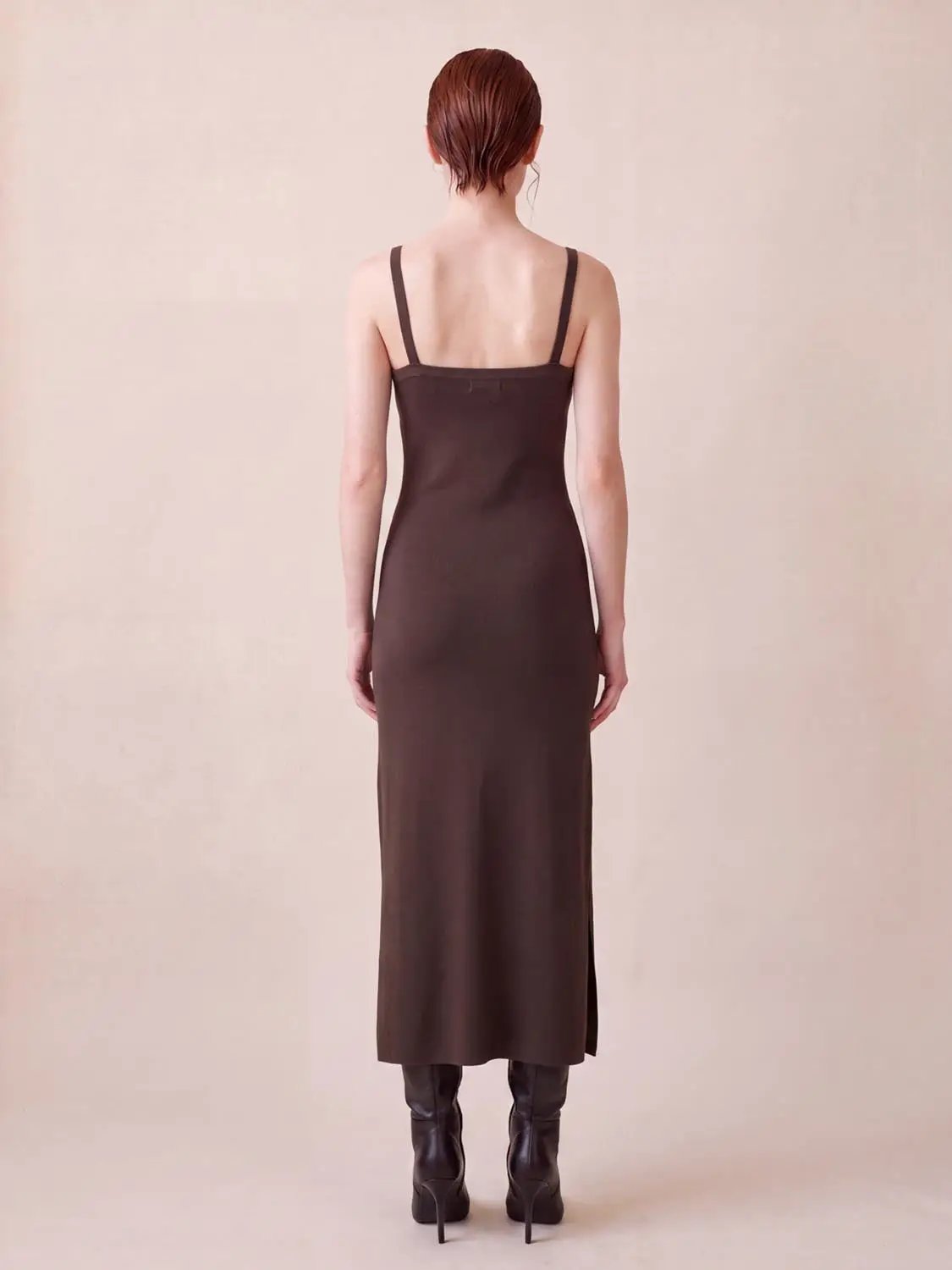 Wide-strap knitted maxi dress in brown, back view on a model, ankle-length with a small side slit.