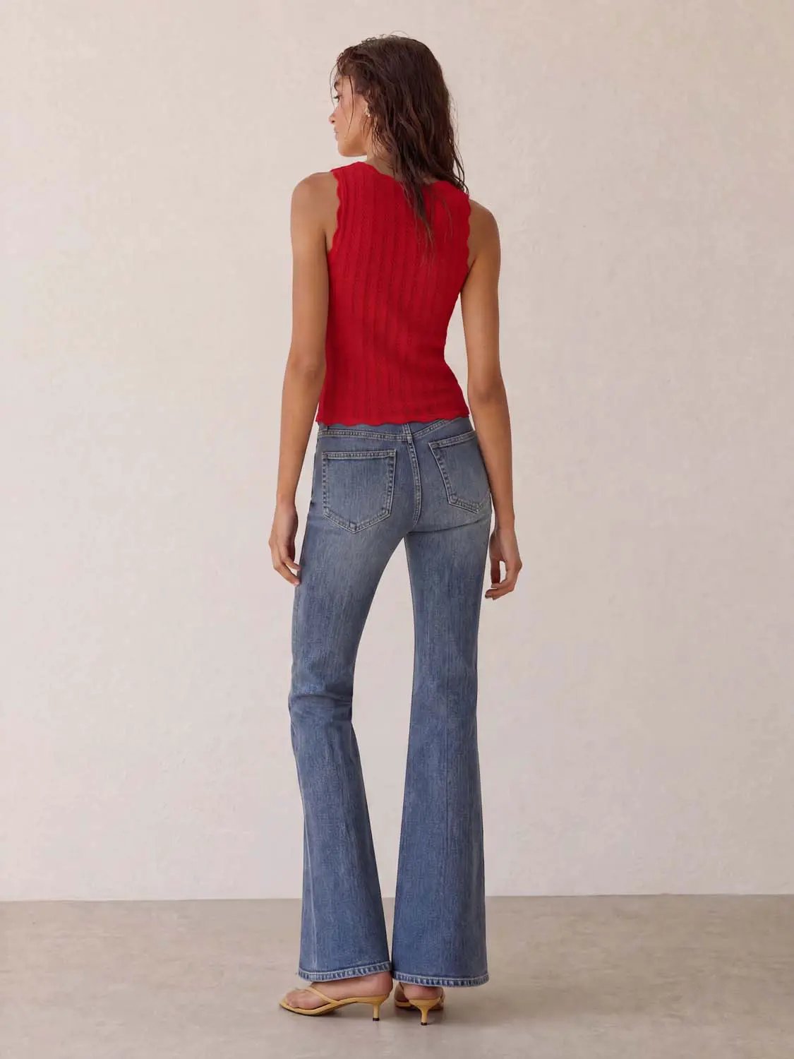 Knit T-Shirt red sleeveless knit top by Urban Revivo Fashion; model in blue denim flared jeans.