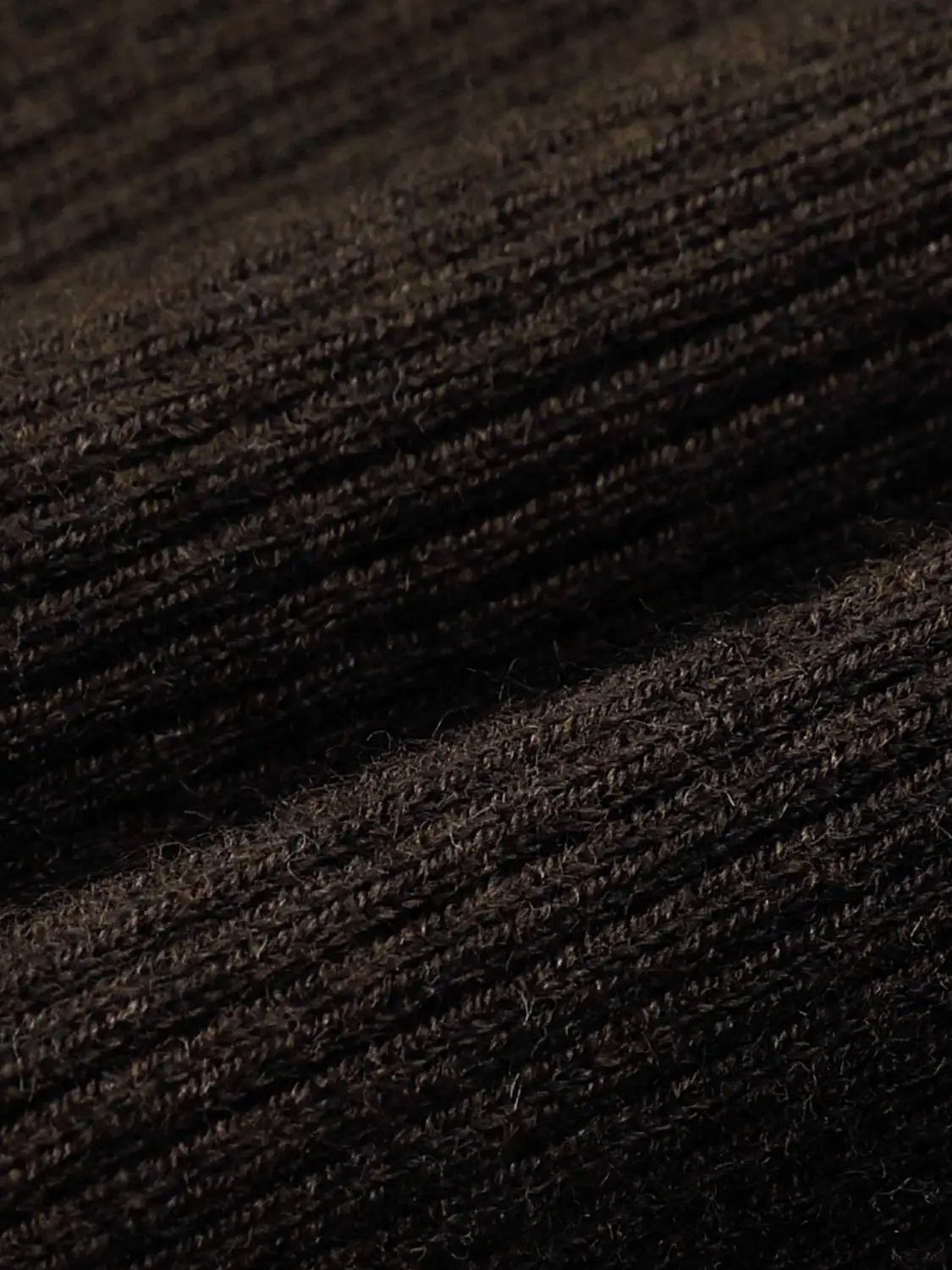 Knit T-Shirt fabric close-up in dark brown, textured knit material