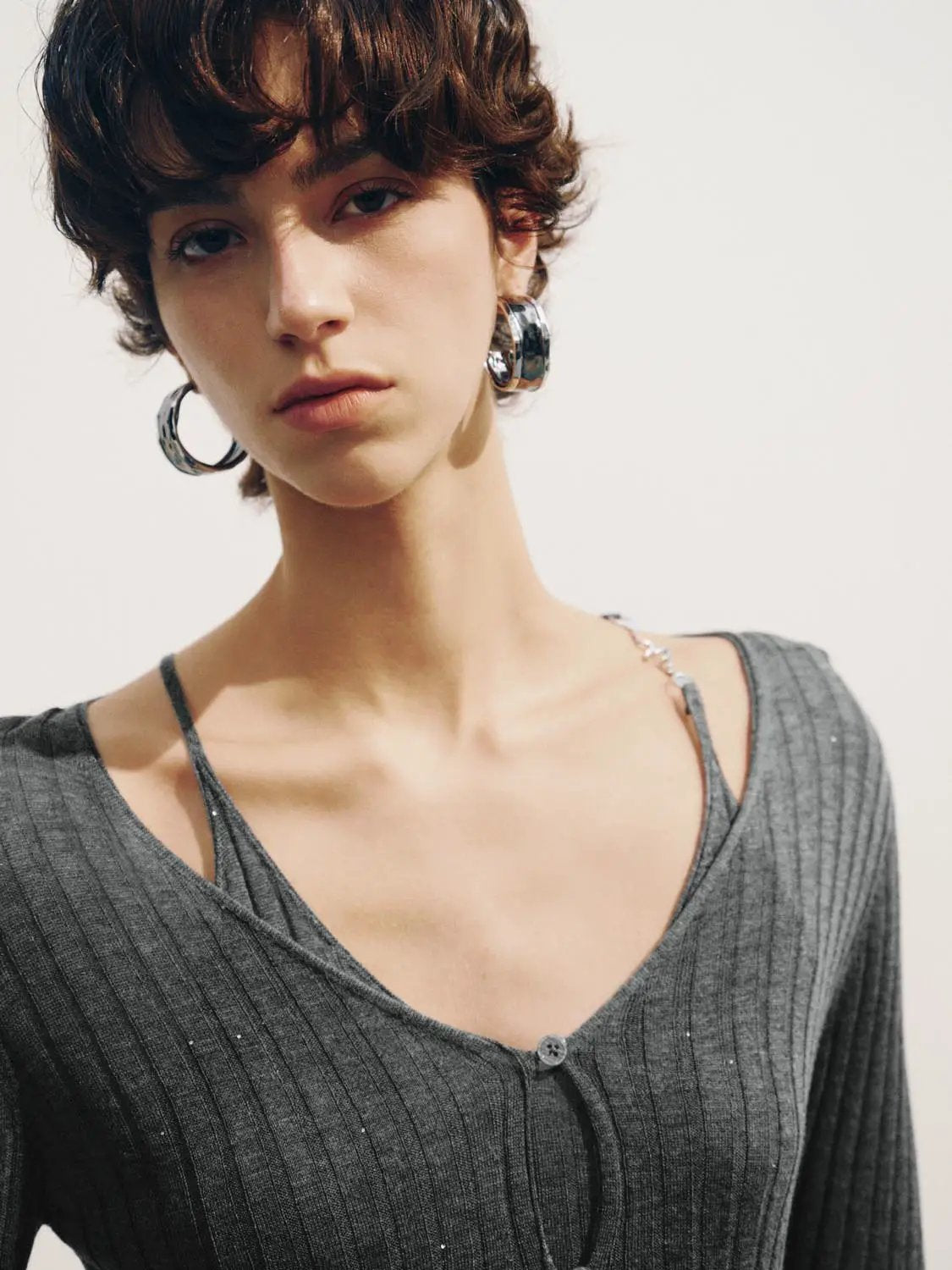 Fitted ribbed V-neck button-front cardigan in gray knit, long sleeves.