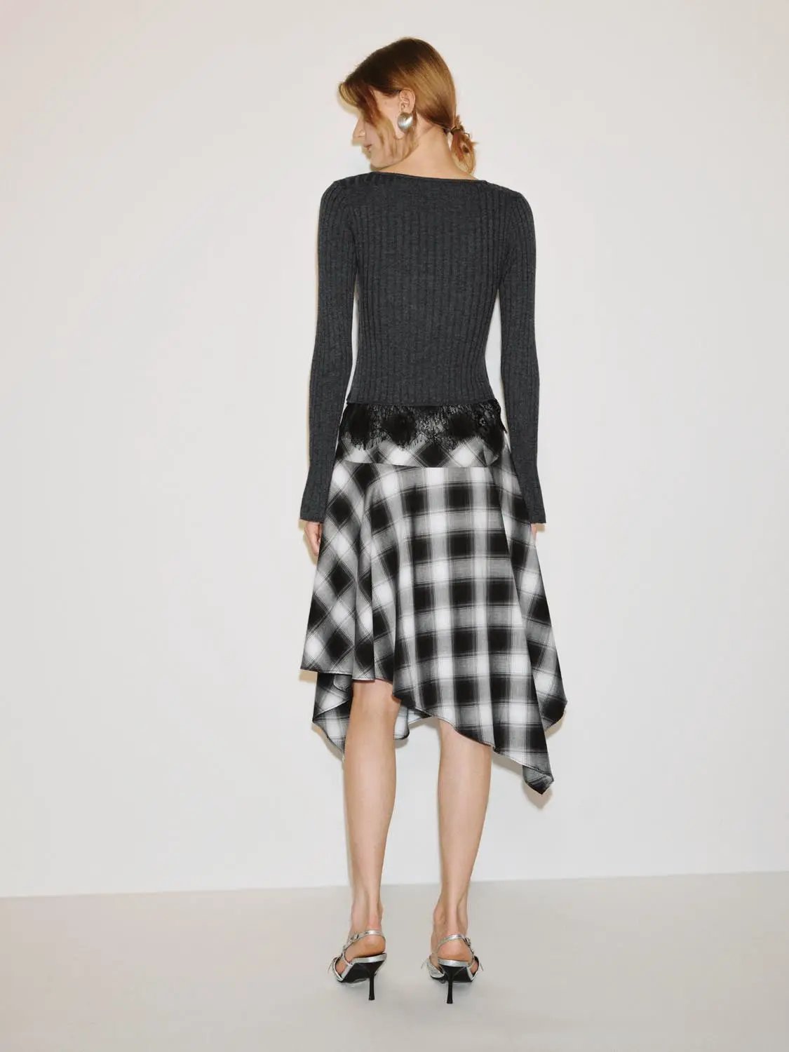 Knitted top; gray ribbed long-sleeve with a black-and-white plaid skirt featuring lace trim