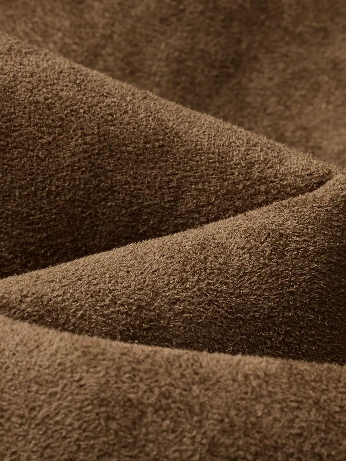 Jacket fabric close-up in brown suede-like texture