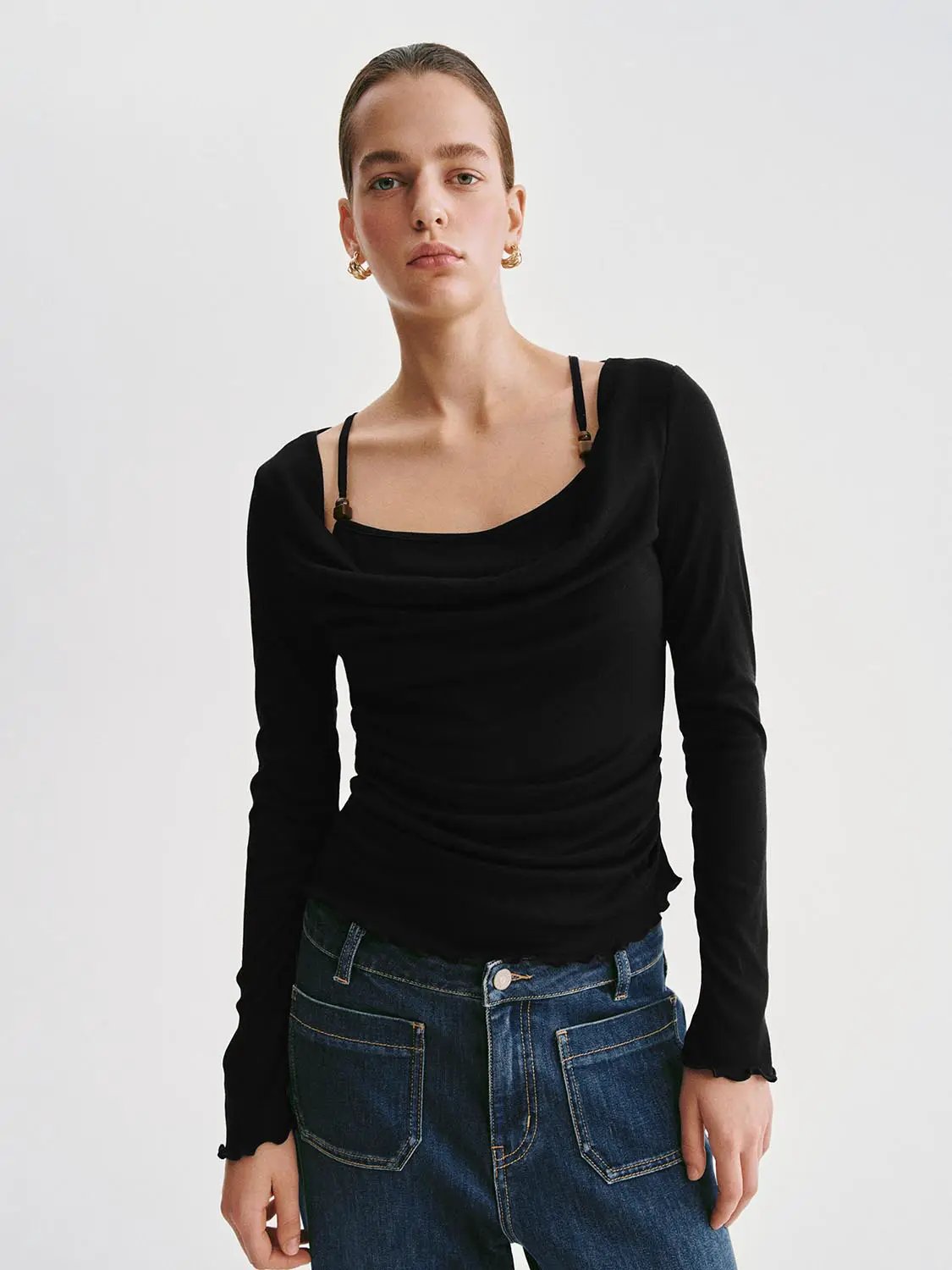 T-shirt, black long-sleeve with draped neckline, on model wearing blue jeans