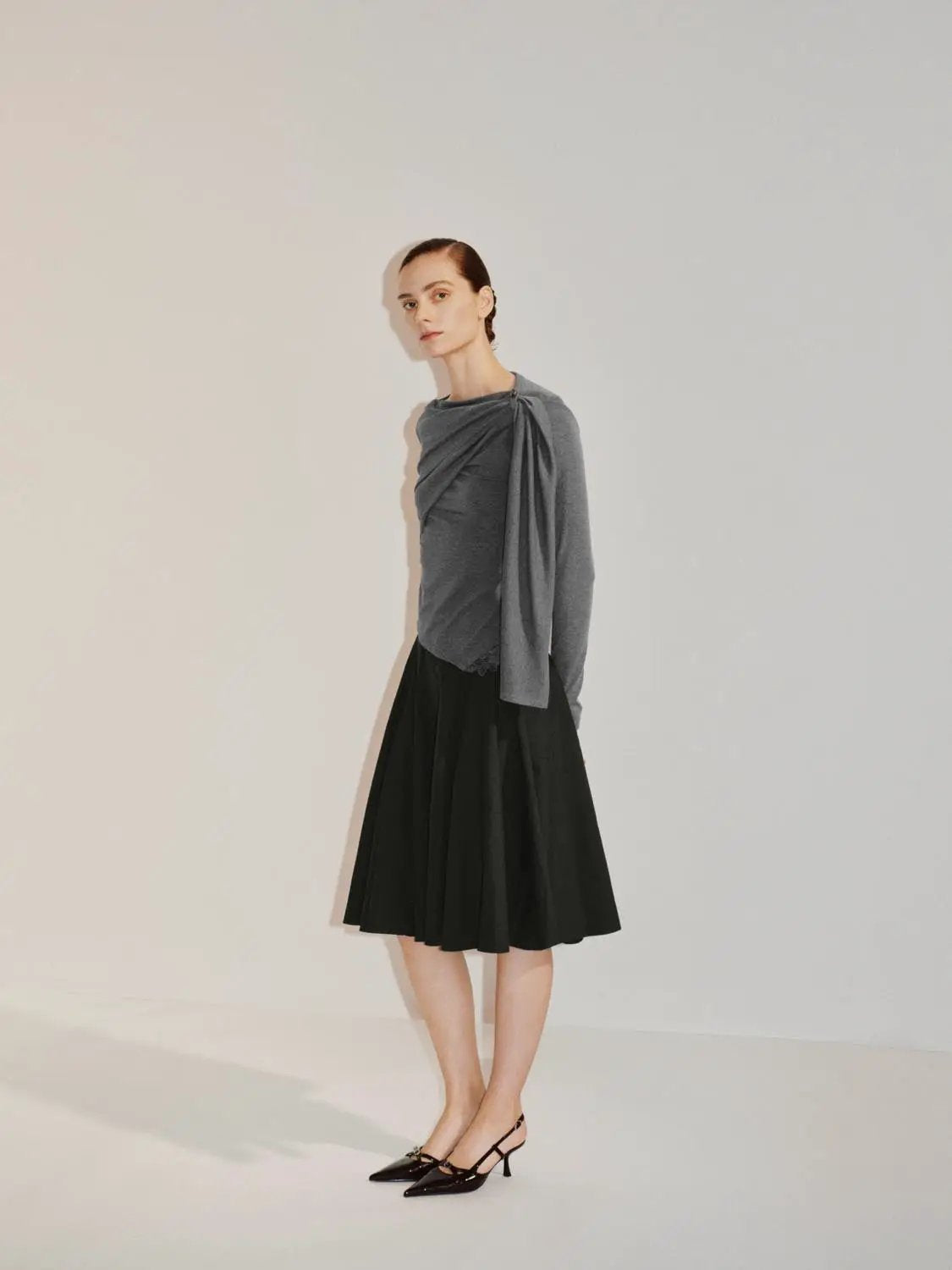 Draped One-Shoulder Long Sleeve Blouse in grey by Urban Revivo Fashion; shown with a black skirt