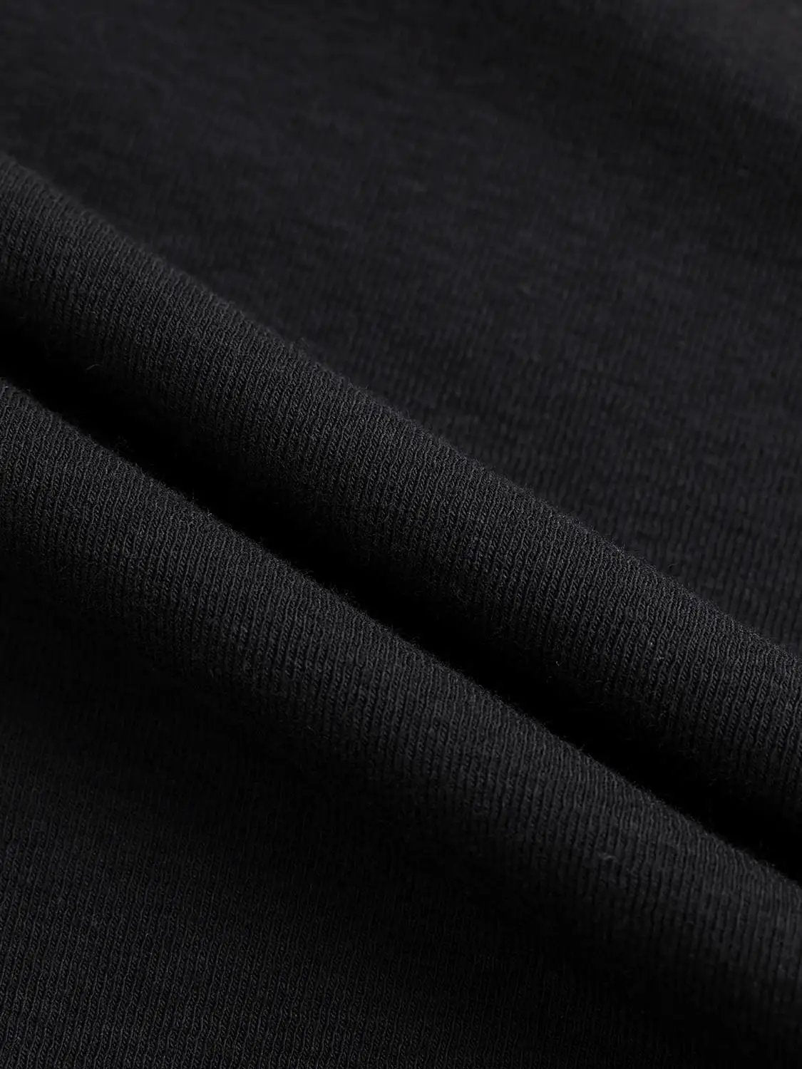 Draped One-Shoulder Long Sleeve Blouse fabric close-up in black jersey knit