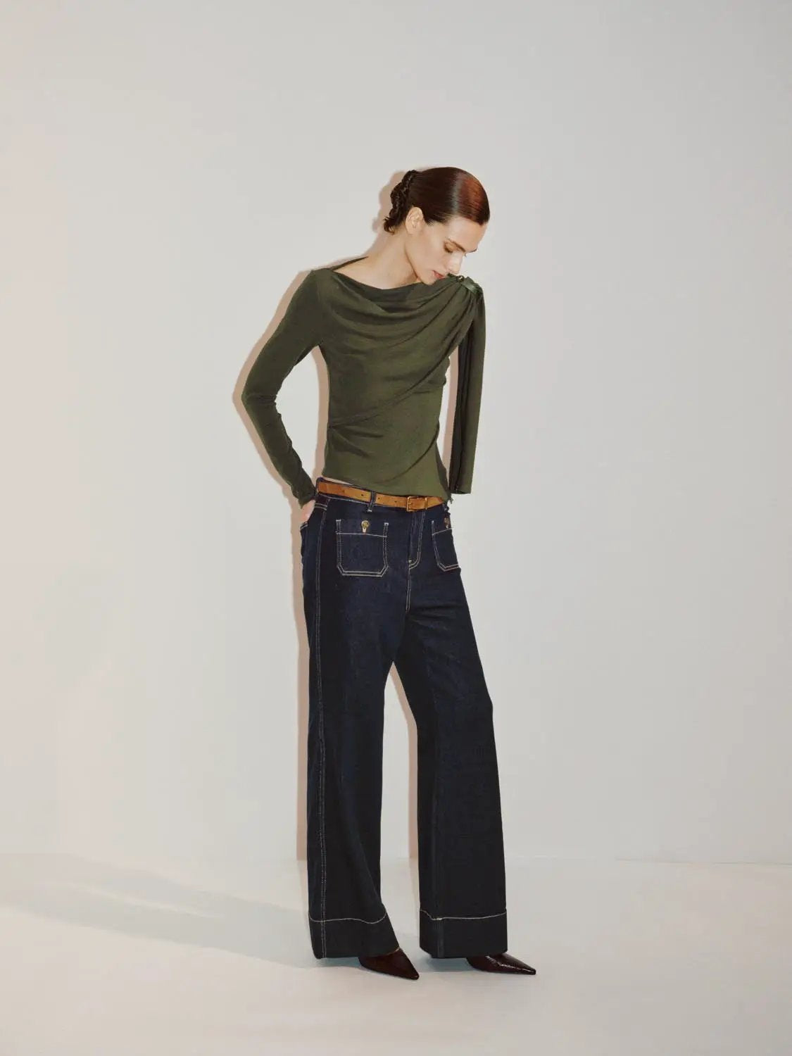 Draped one-shoulder long-sleeve blouse in olive green by Urban Revivo Fashion; shown with dark wide-leg jeans.